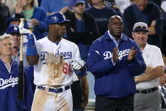 LOS ANGELES, CA - OCTOBER 07:  Yasiel Puig #66 of the Los Angeles Dodgers waits on deck next to Earvin 'Magic' Johnson in the eighth inning against the Atlanta Braves in Game Four of the National League Division Series at Dodger Stadium on October 7, 2013