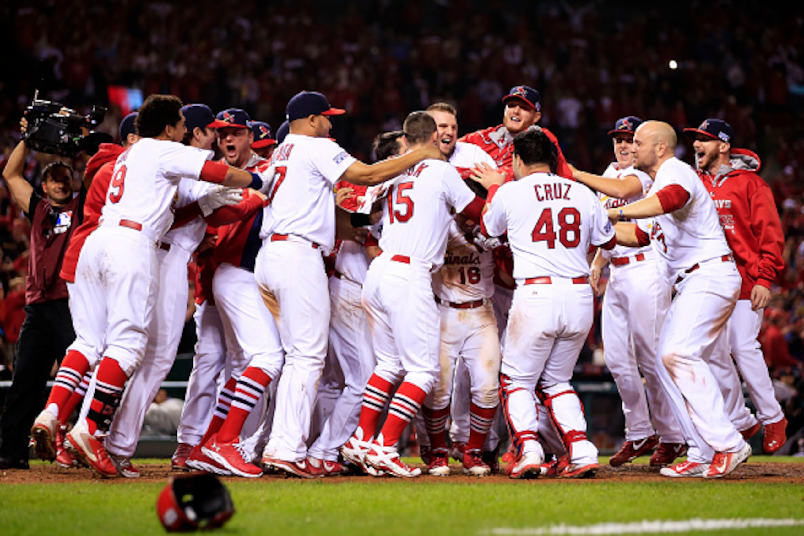ST LOUIS, MO - OCTOBER 12:  Kolten Wong #16 of the St. Louis Cardinals celebrates his solo home run in the ninth inning to give the St. Louis Cardinals the 5 to 4 win over the San Francisco Giants with teammates during Game Two of the National League Cham