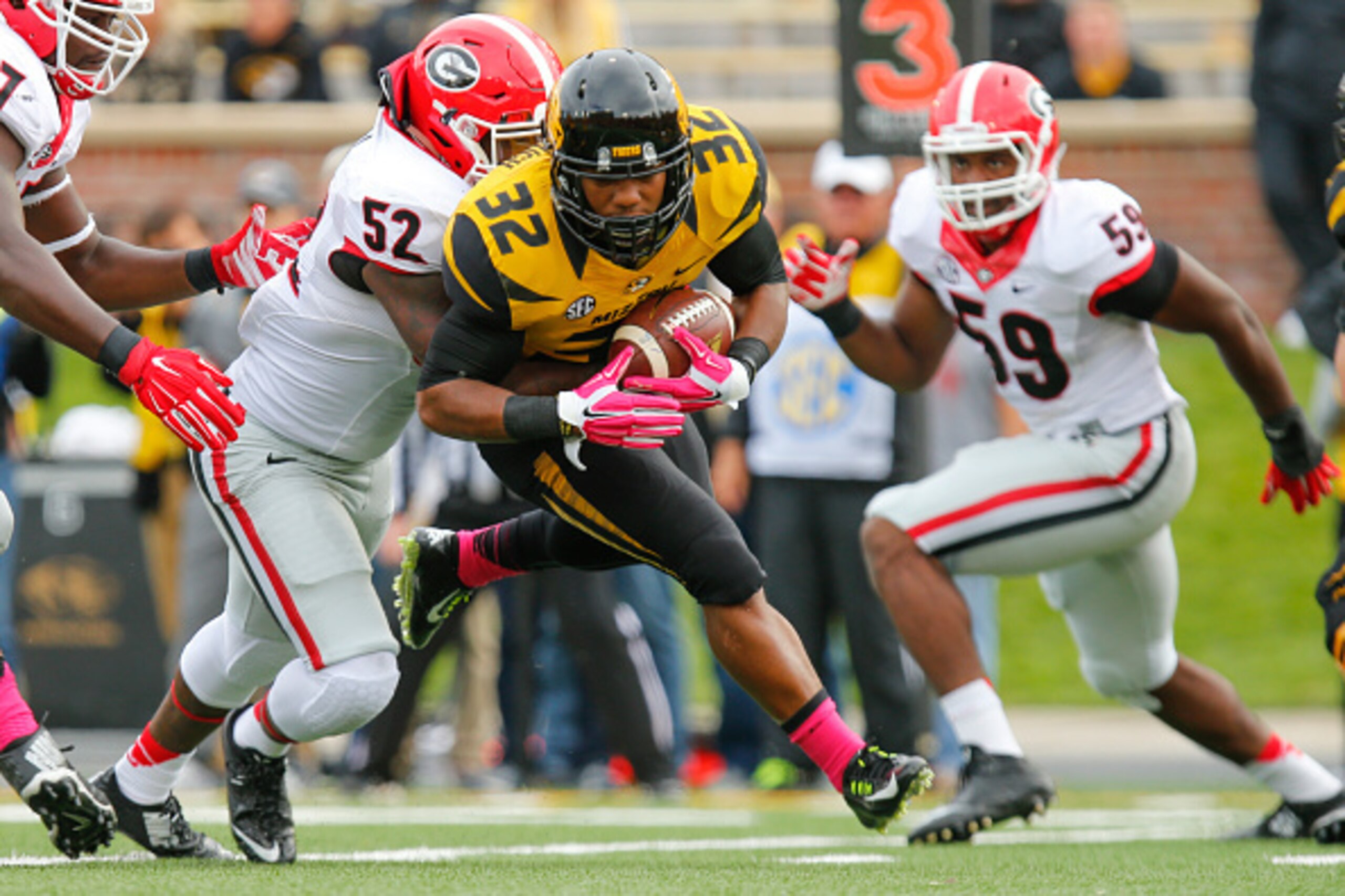 COLUMBIA, MO - OCTOBER 11:  Russell Hansbrough #32 of the Missouri Tigers is taken to the ground by Amarlo Herrera #52 of the Georgia Bulldogs early in the fourth quarter on October 11, 2014 at Faurot Field/Memorial Stadium in Columbia, Missouri. (Photo b