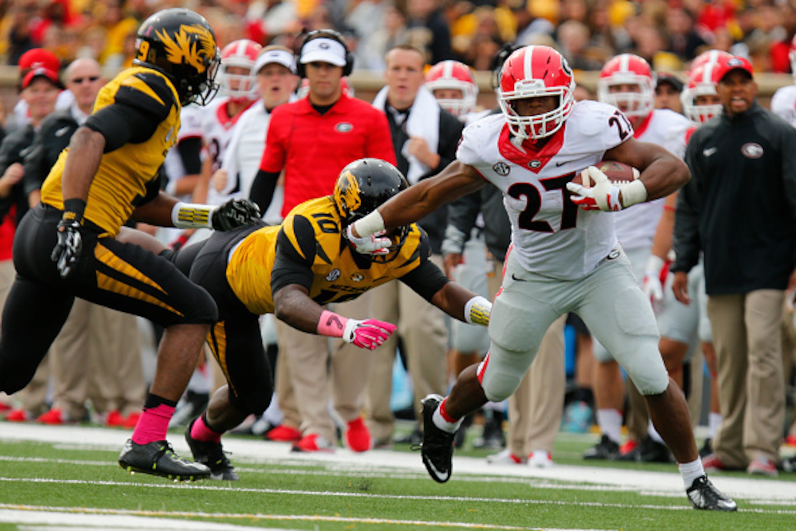 COLUMBIA, MO - OCTOBER 11:  Nick Chubb #27 of the Georgia Bulldogs pushes off Kentrell Brothers #10 of the Missouri Tigers as he drives up the field late in the third quarter on October 11, 2014 at Faurot Field/Memorial Stadium in Columbia, Missouri. (Pho