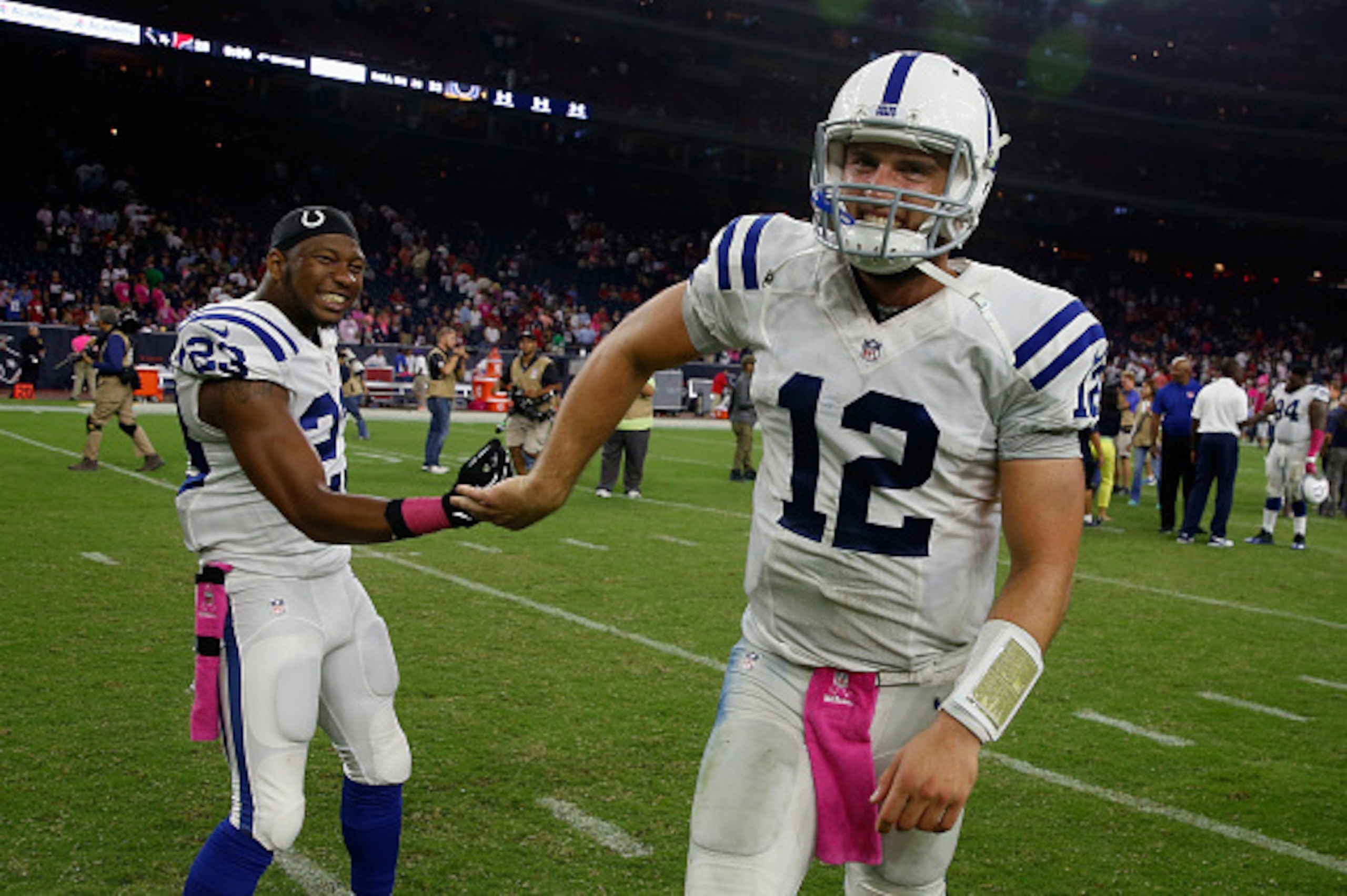 HOUSTON, TX - OCTOBER 09:  Andrew Luck #12 and Loucheiz Purifoy #23 of the Indianapolis Colts walk off the field after defeating the Houston Texans 33-28 at NRG Stadium on October 9, 2014 in Houston, Texas.  (Photo by Scott Halleran/Getty Images)