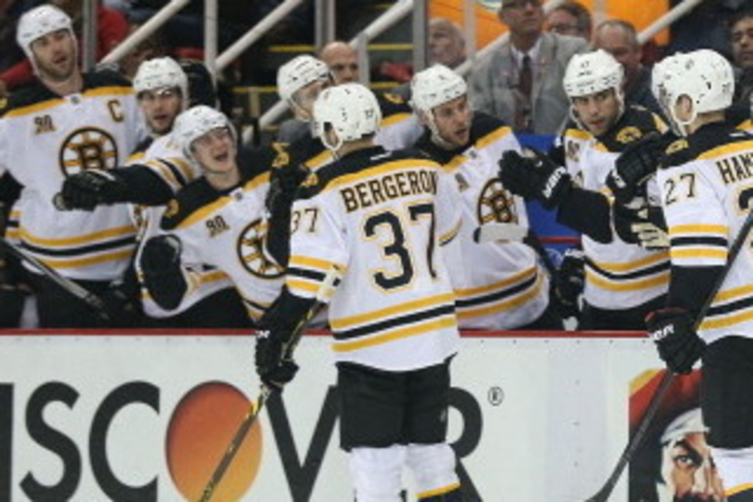 DETROIT, MI - APRIL 22:  Dougie Hamilton #27 of the Boston Bruins celebrates with the bench after scoring a first-period goal against the Detroit Red Wings in Game Three of the First Round of the 2014 NHL Stanley Cup Playoffs at Joe Louis Arena on April 2