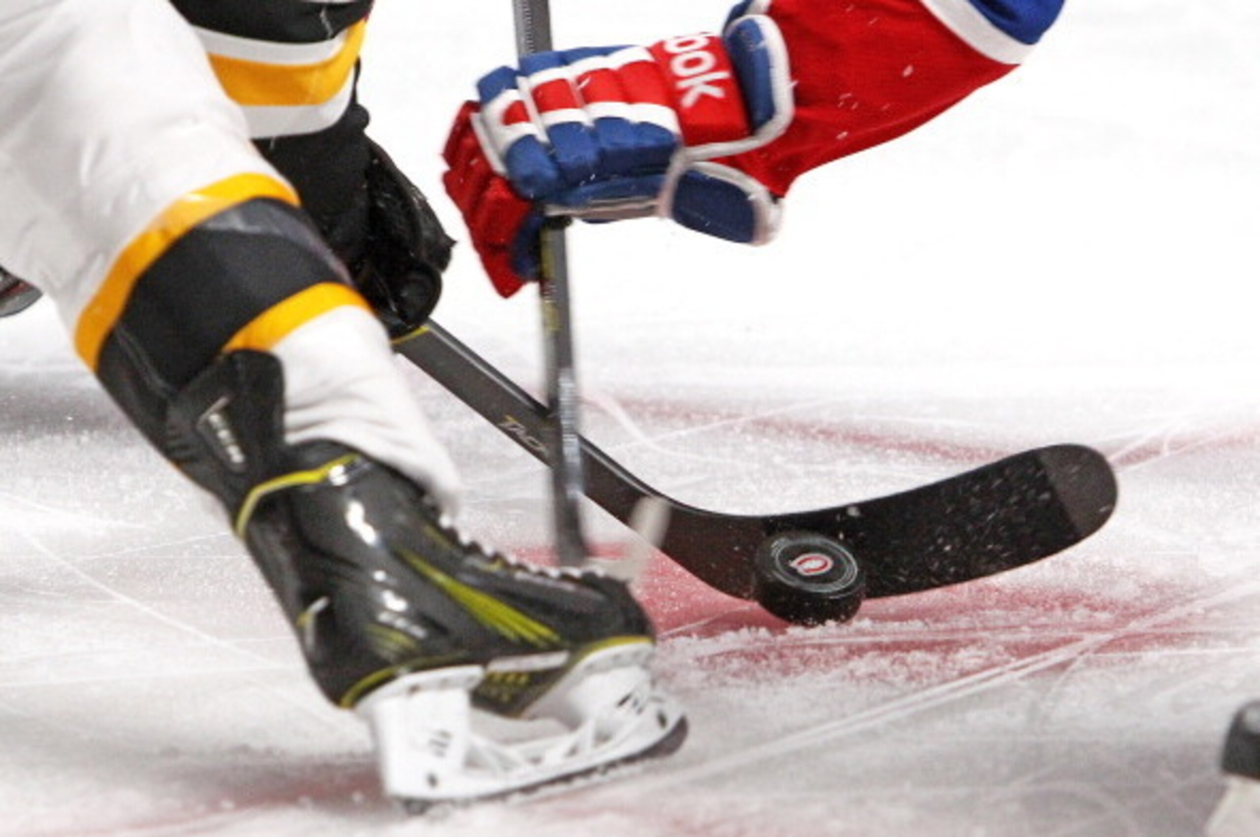 MONTREAL, QC - MAY 12: The puck bounces on the ice during a face-off between the Montreal Canadiens and the Boston Bruins in Game Six of the Second Round of the 2014 NHL Stanley Cup Playoffs at the Bell Centre on May 12, 2014 in Montreal, Quebec, Canada. 