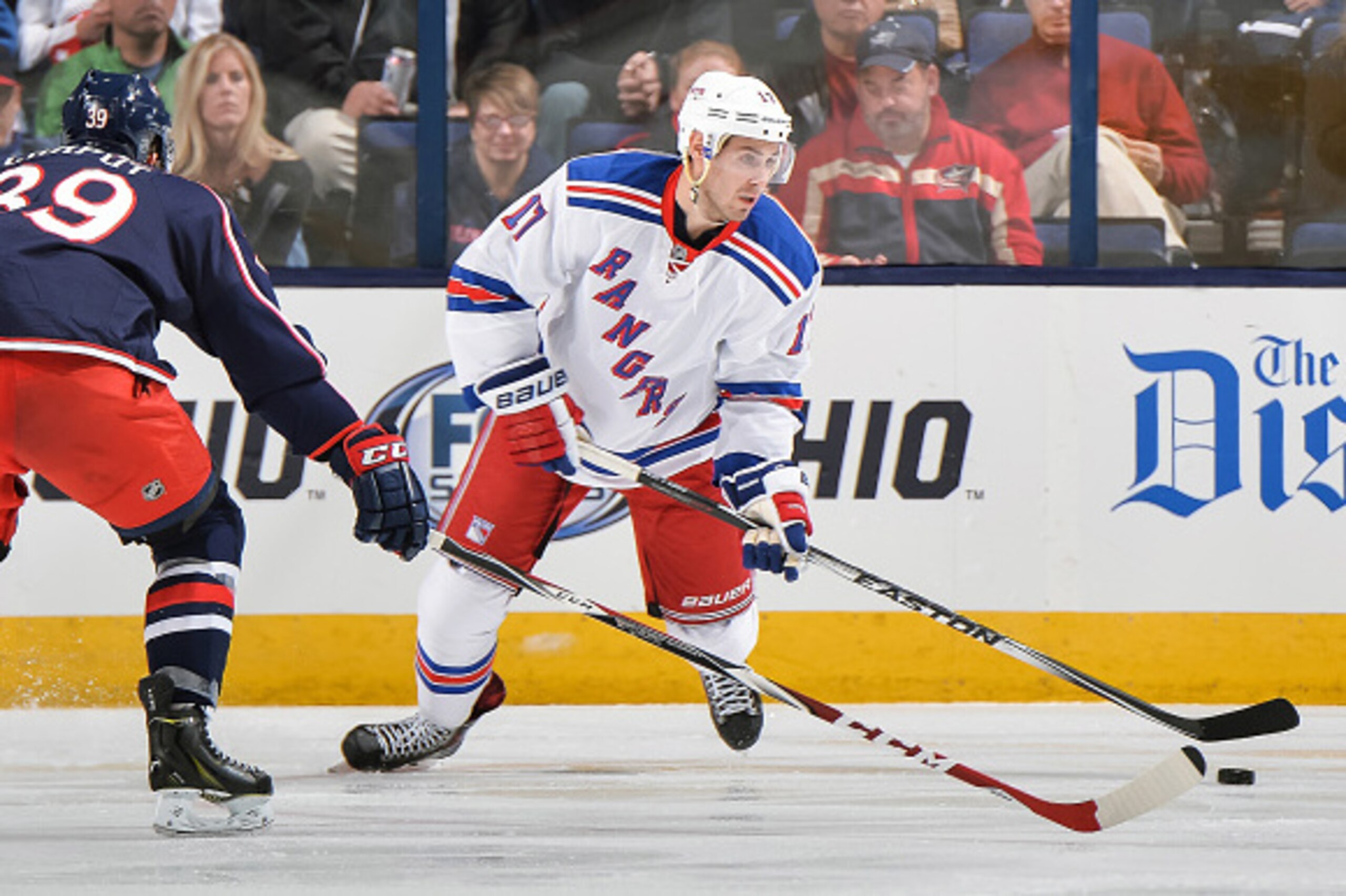 COLUMBUS, OH - OCTOBER 11: John Moore #17 of the New York Rangers skates with the puck against the Columbus Blue Jackets on October 11, 2014 at Nationwide Arena in Columbus, Ohio. (Photo by Jamie Sabau/NHLI via Getty Images) COLUMBUS, OH - OCTOBER 11: John Moore #17 of the New York Rangers skates with the puck against the Columbus Blue Jackets on October 11, 2014 at Nationwide Arena in Columbus, Ohio. (Photo by Jamie Sabau/NHLI via Getty Images)