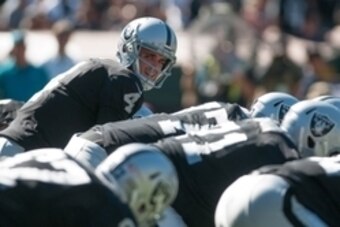 Oct 12, 2014; Oakland, CA, USA; Oakland Raiders quarterback Derek Carr (4) prepares to snap the ball against the San Diego Chargers during the first quarter at O.co Coliseum. The San Diego Chargers defeated the Oakland Raiders 31-28. Mandatory Credit: Ed 