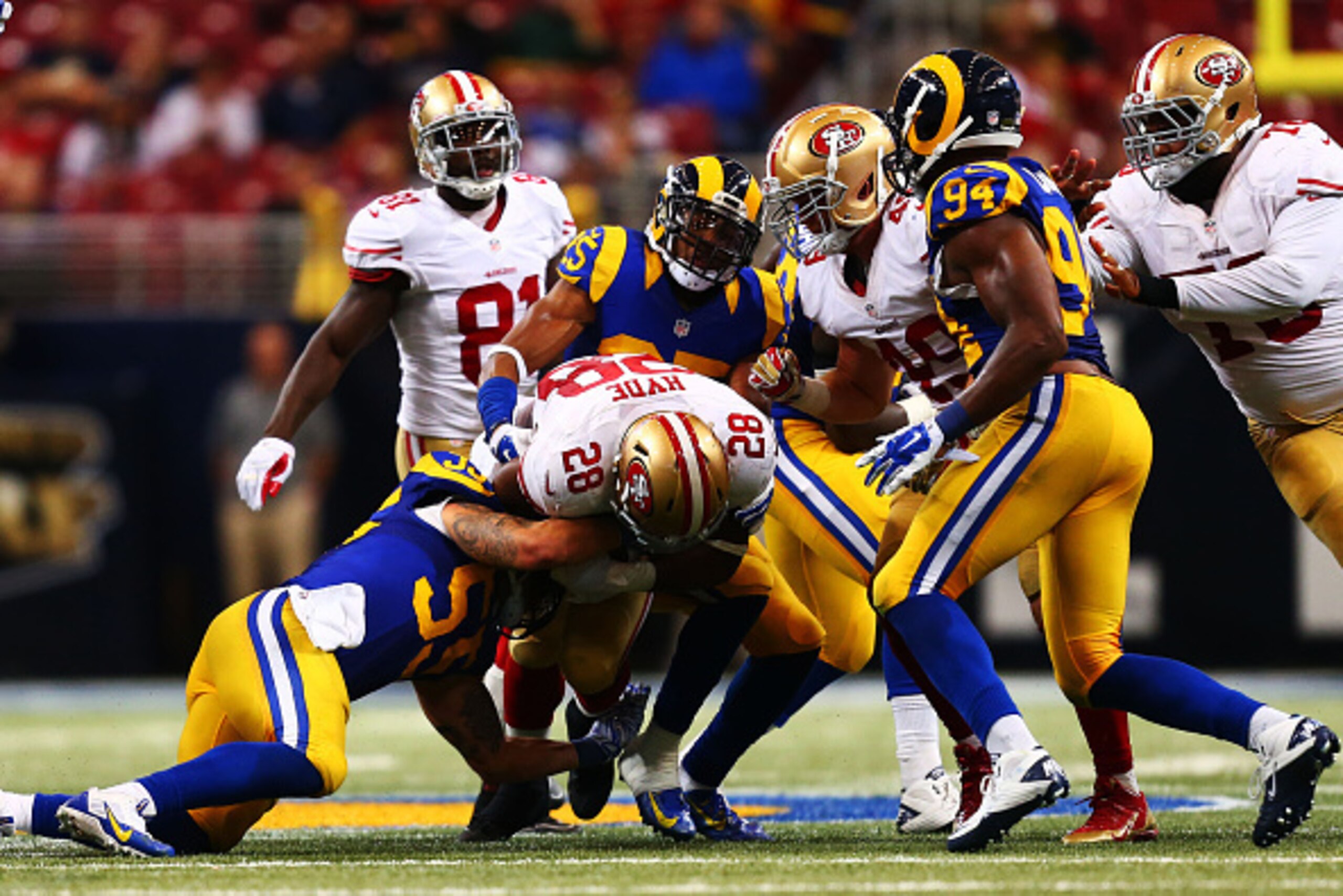 ST LOUIS, MO - OCTOBER 13:   Carlos Hyde #28 of the San Francisco 49ers is tackled by  James Laurinaitis #55 of the St. Louis Rams in the fourth quarter at Edward Jones Dome on October 13, 2014 in St Louis, Missouri.  (Photo by Dilip Vishwanat/Getty Image