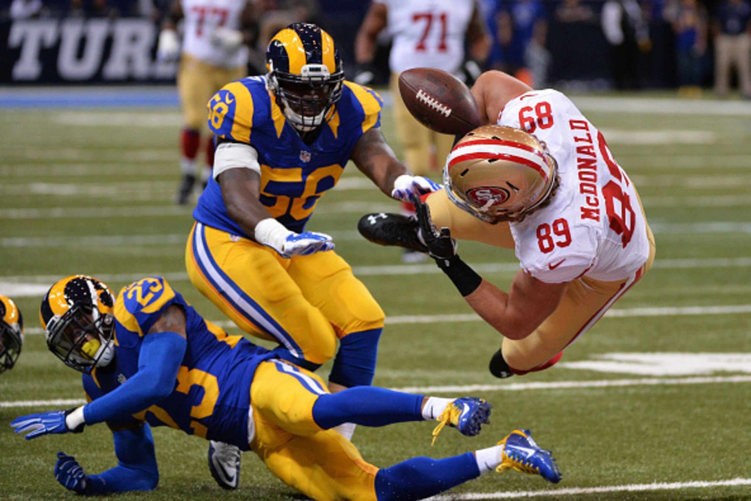ST LOUIS, MO - OCTOBER 13:  Vance McDonald #89 of the San Francisco 49ers fumbles the ball as he is tackled by  Rodney McLeod #23 and  Jo-Lonn Dunbar #58 of the St. Louis Rams in the first quarter  at Edward Jones Dome on October 13, 2014 in St Louis, Mis