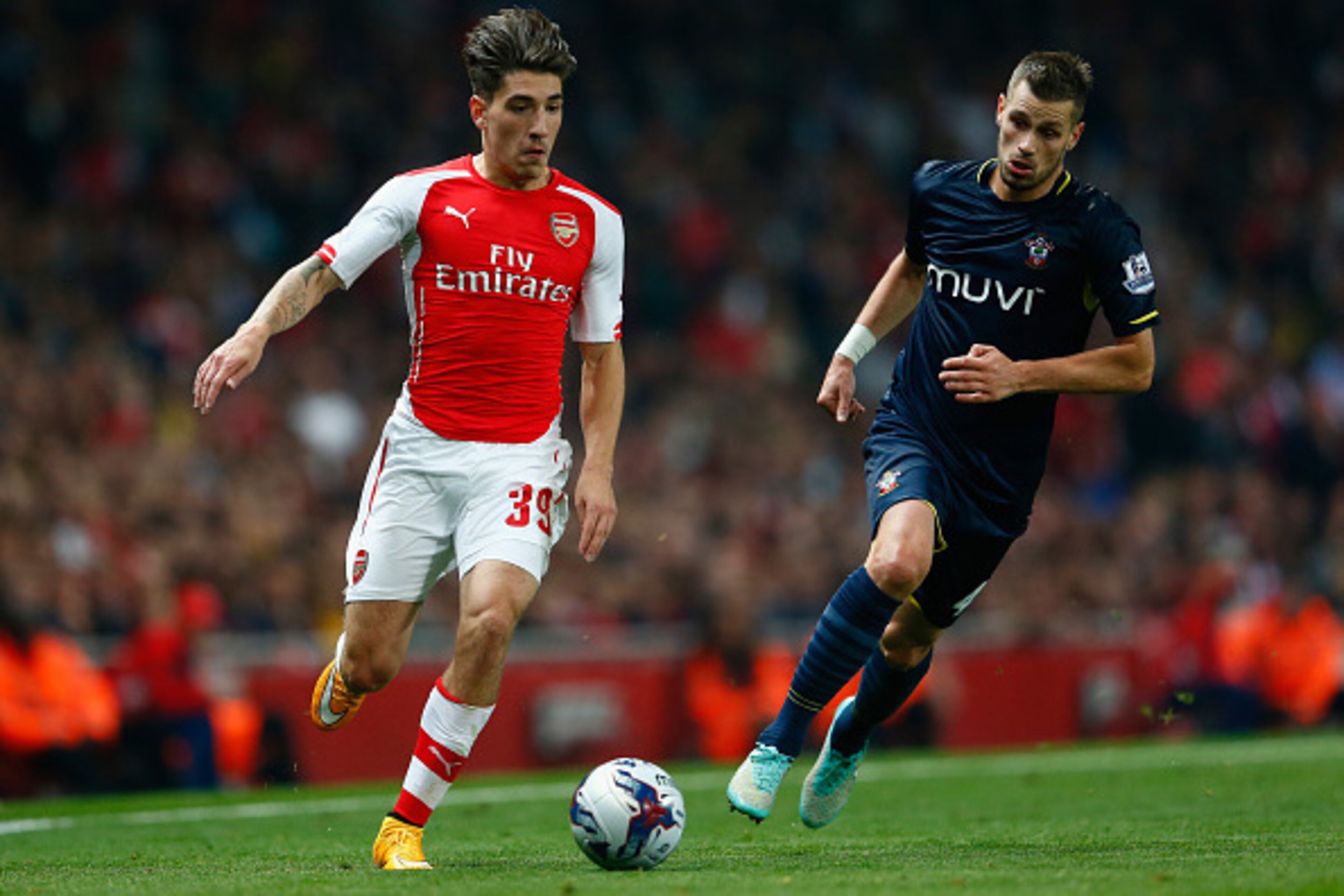 LONDON, ENGLAND - SEPTEMBER 23:  Hector Bellerin of Arsenal moves away from Morgan Schneiderlin of Southampton during the Capital One Cup Third Round match between Arsenal and Southampton at the Emirates Stadium on September 23, 2014 in London, England.  