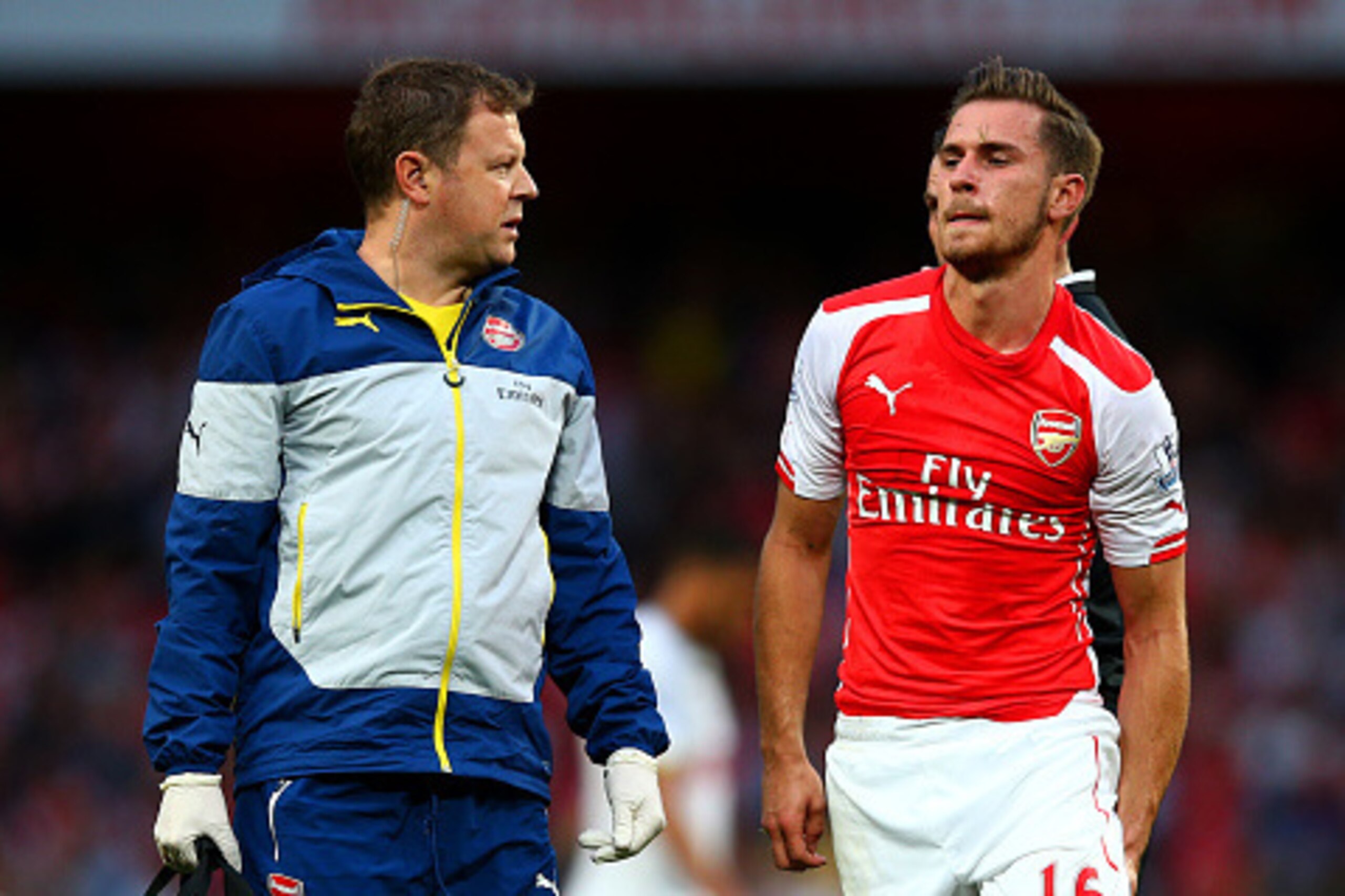 LONDON, ENGLAND - SEPTEMBER 27:  Aaron Ramsey of Arsenal holds his leg as he walks off the pitch after picking up an injury during the Barclays Premier League match between Arsenal and Tottenham Hotspur at Emirates Stadium on September 27, 2014 in London,
