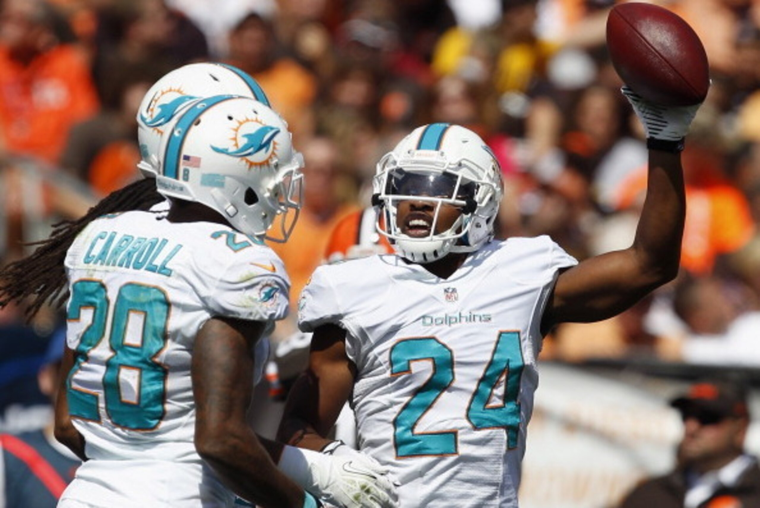 CLEVELAND, OH - SEPTEMBER 08:  Cornerback Dimitri Patterson #24 of the Miami Dolphins celebrates with cornerback Nolan Carroll #28 after an interception against the Cleveland Browns at Cleveland Browns Stadium on September 8, 2013 in Cleveland, Ohio.  (Ph