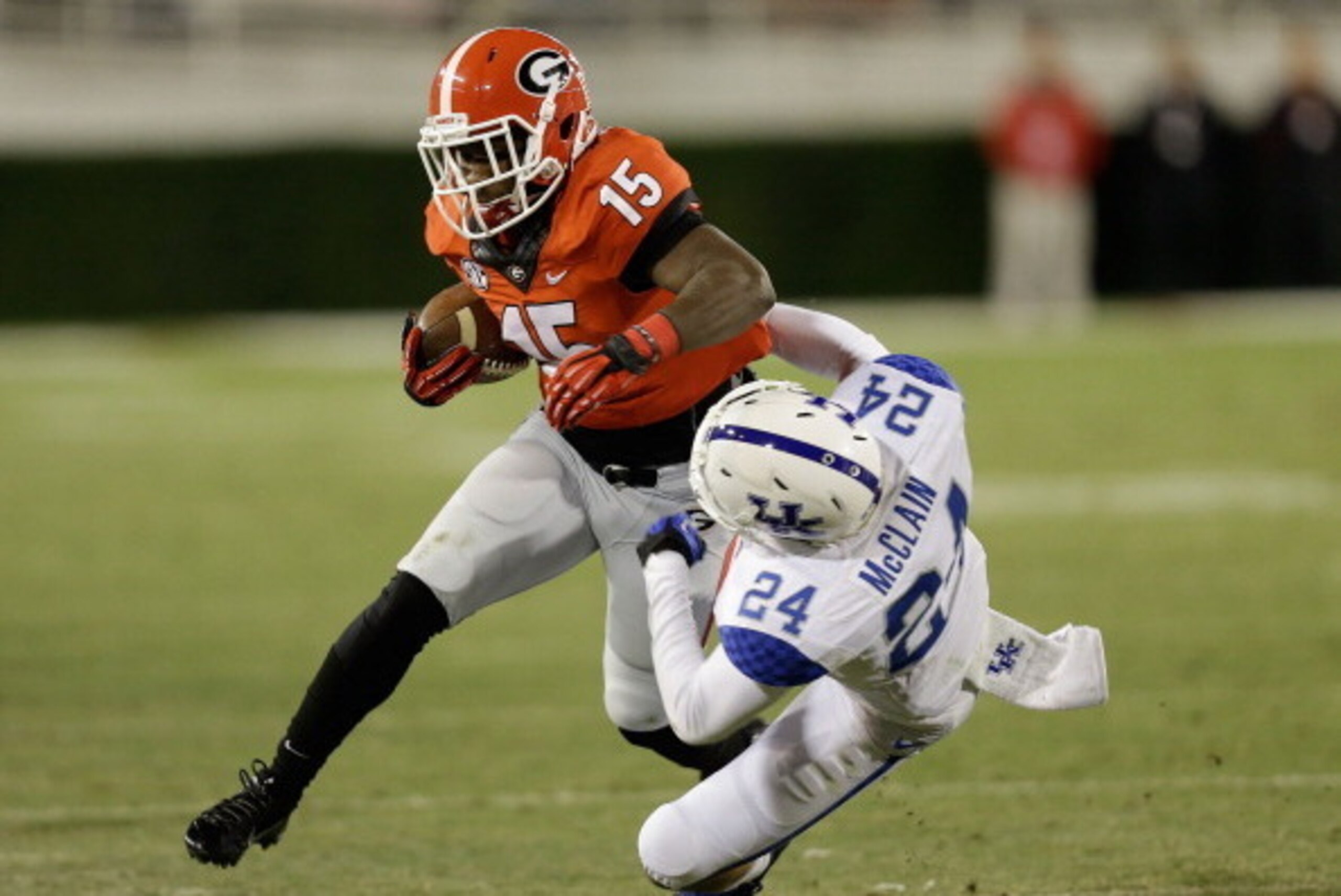 ATHENS, GA - NOVEMBER 23:  Running back J.J. Green #15 of the Georgia Bulldogs runs over defensive back Blake McClain #24 of the Kentucky Wildcats during the game at Sanford Stadium on November 23, 2013 in Athens, Georgia.  (Photo by Mike Zarrilli/Getty I