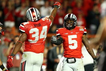 MIAMI GARDENS, FL - JANUARY 03: Carlos Hyde #34 and Braxton Miller #5 of the Ohio State Buckeyes celebrate after a touchdown by Hyde in the third quarter against the Clemson Tigers during the Discover Orange Bowl at Sun Life Stadium on January 3, 2014 in 