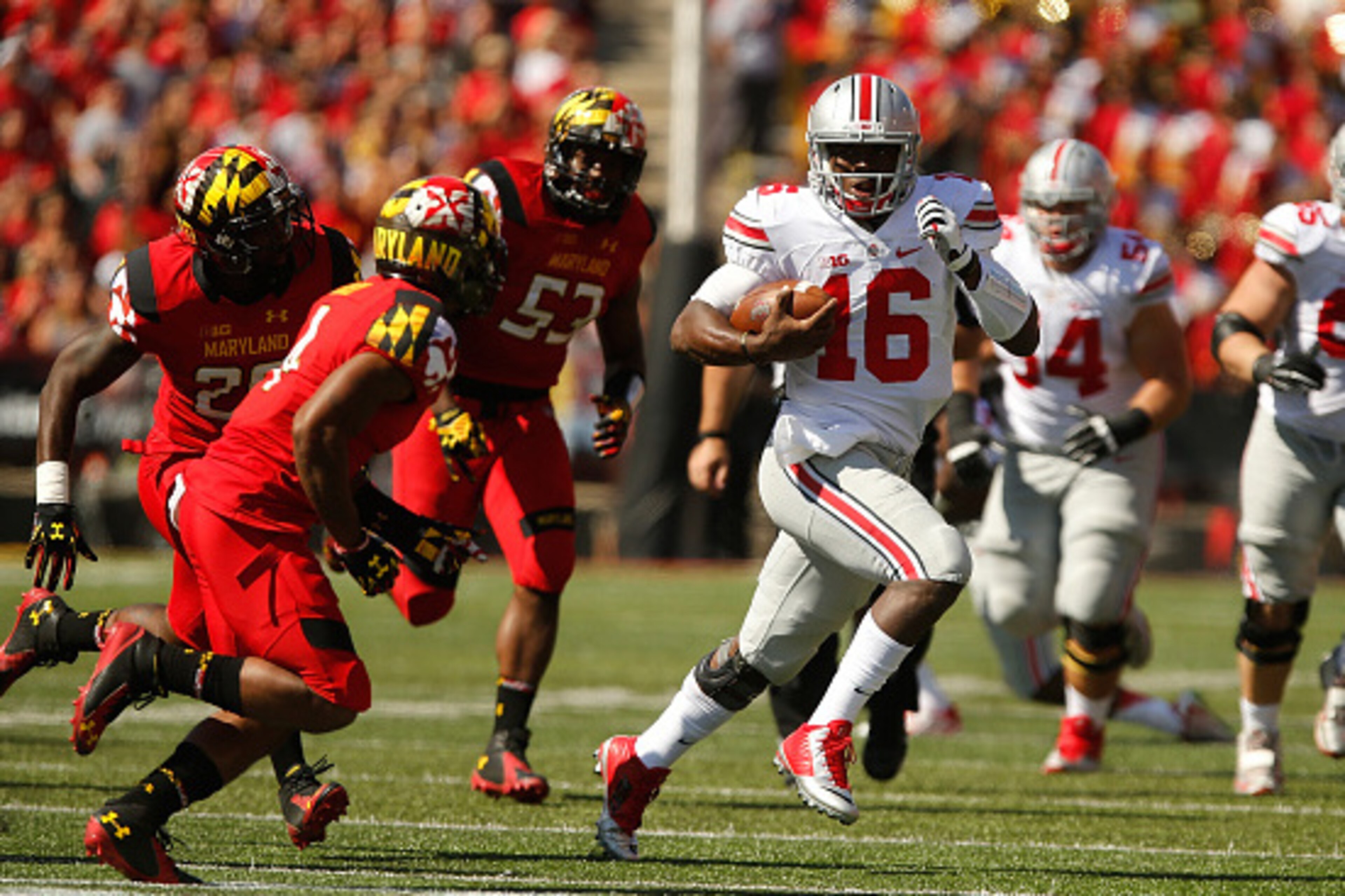 COLLEGE PARK, MD - OCTOBER 04:  Quarterback J.T. Barrett #16 of the Ohio State Buckeyes runs with the ball against the Maryland Terrapin defense during the first half of Ohio State's 52-24 win at Byrd Stadium on October 4, 2014 in College Park, Maryland. 