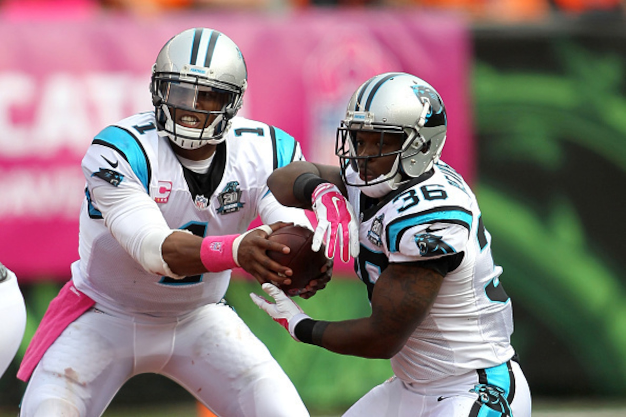 CINCINNATI, OH - OCTOBER 12:  Cam Newton #1 of the Carolina Panthers fakes a handoff to Darrin Reaves #36 during the third quarter against the Cincinnati Bengals at Paul Brown Stadium on October 12, 2014 in Cincinnati, Ohio. (Photo by John Grieshop/Getty 