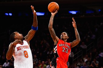 NEW YORK, NY - OCTOBER 13: Louis Williams #23 of the Toronto Raptors shoots against J.R. Smith #8 of the New York Knicks in the first half at Madison Square Garden on October 13, 2014 in New York City. NOTE TO USER: User expressly acknowledges and agrees 