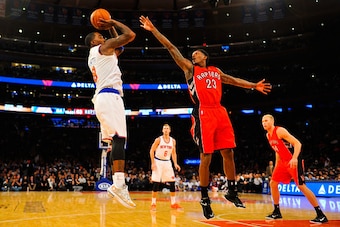 NEW YORK, NY - OCTOBER 13:  J.R. Smith #8 of the New York Knicks shoots over Louis Williams #23 of the Toronto Raptors in the second half at Madison Square Garden on October 13, 2014 in New York City. NOTE TO USER: User expressly acknowledges and agrees t