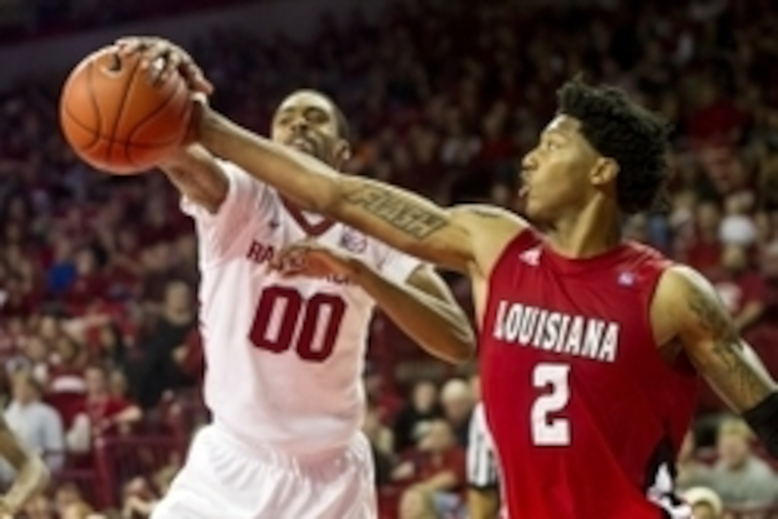 Nov 15, 2013; Fayetteville, Ar, USA; Louisiana-Lafayette Ragin' Cajuns guard Elfrid Payton (2) and Arkansas Razorback guard Rashad Madden (00) battle for control of a rebound during the second half at Bud Walton Arena Arena. Arkansas defeated Louisiana-La
