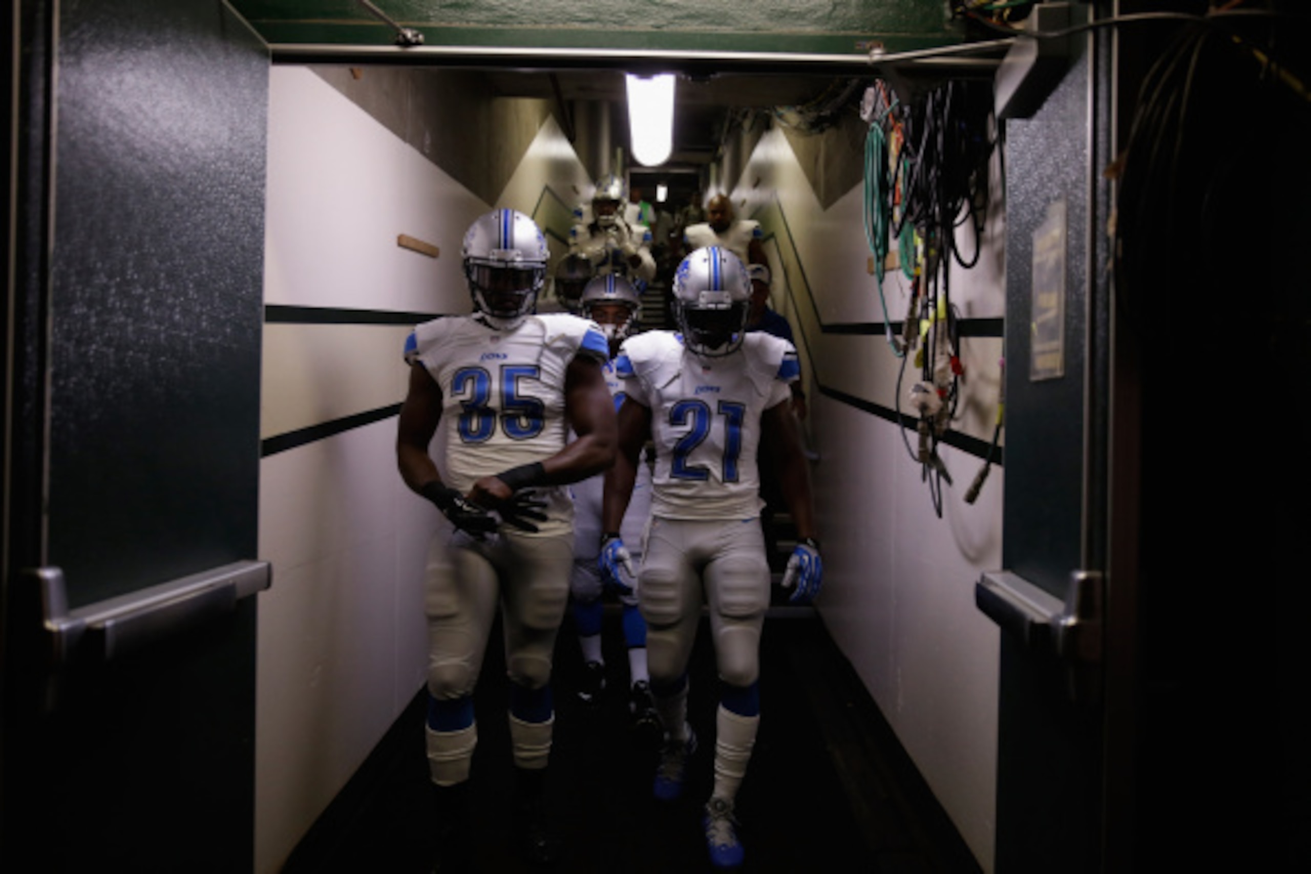 OAKLAND, CA - AUGUST 15:  Joique Bell #35 and Reggie Bush #21 of the Detroit Lions walk down the tunnel for their game against the Oakland Raiders during their preseason game at O.co Coliseum on August 15, 2014 in Oakland, California.  (Photo by Ezra Shaw