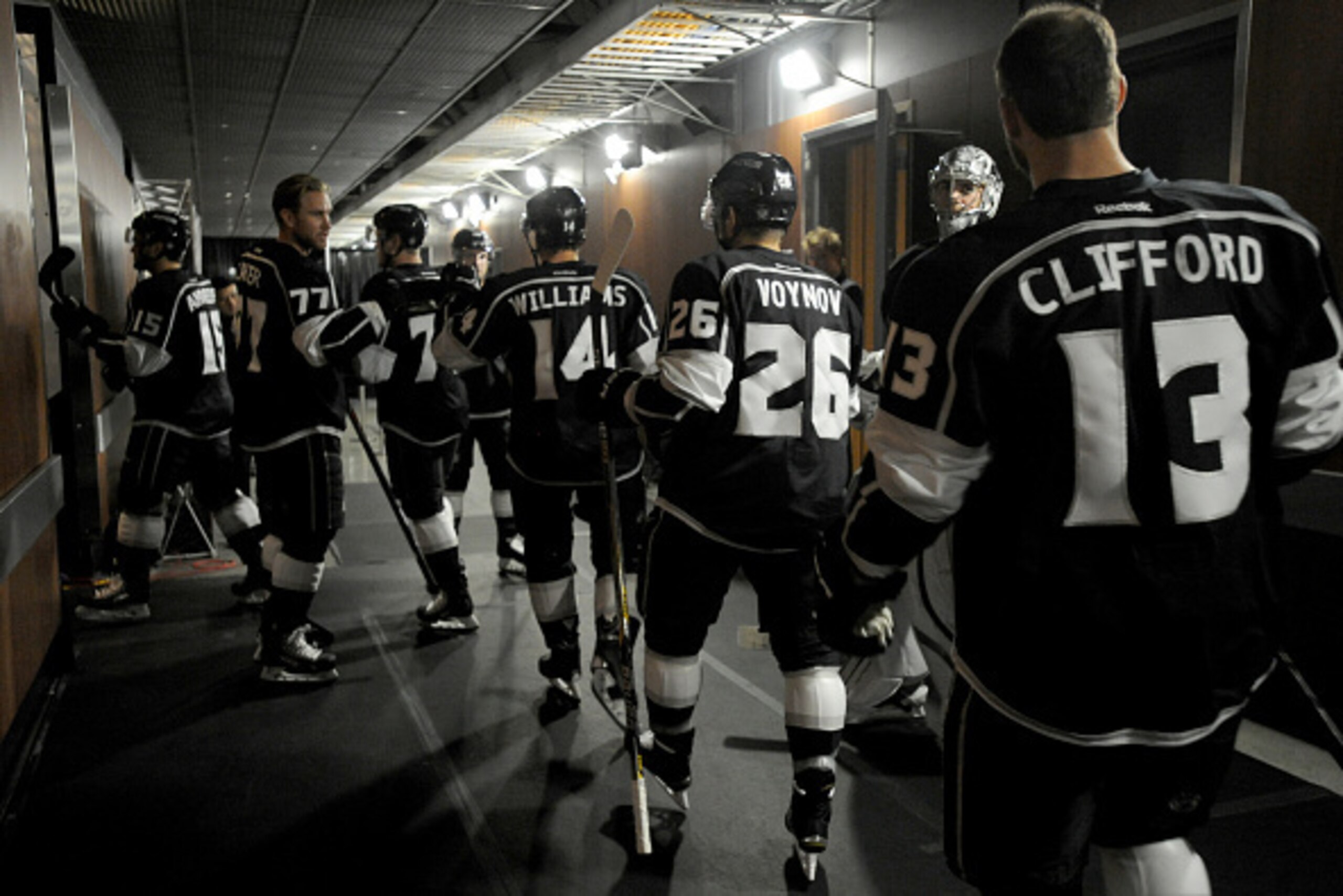 LOS ANGELES, CA - OCTOBER 14: Andy Andreoff #15, Jeff Carter #77, Jordan Nolan #71, Justin Williams #14, Slava Voynov #26, and Kyle Clifford #13 of the Los Angeles Kings make their way from the locker room to the ice before a game against the Edmonton Oil