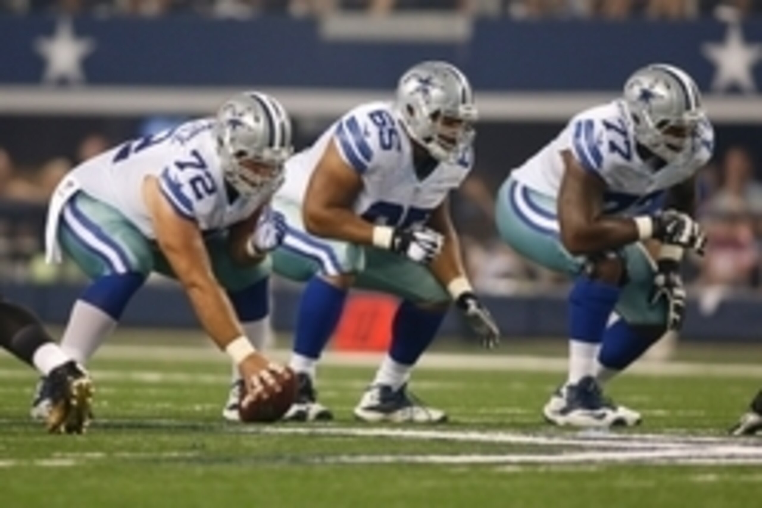 Sep 28, 2014; Arlington, TX, USA; Dallas Cowboys center Travis Frederick (72), guard Ronald Leary (65) and  tackle Tyron Smith (77) on the line of scrimmage against the New Orleans Saints at AT&T Stadium. Dallas beat New Orleans 38-17. Mandatory Credit: T