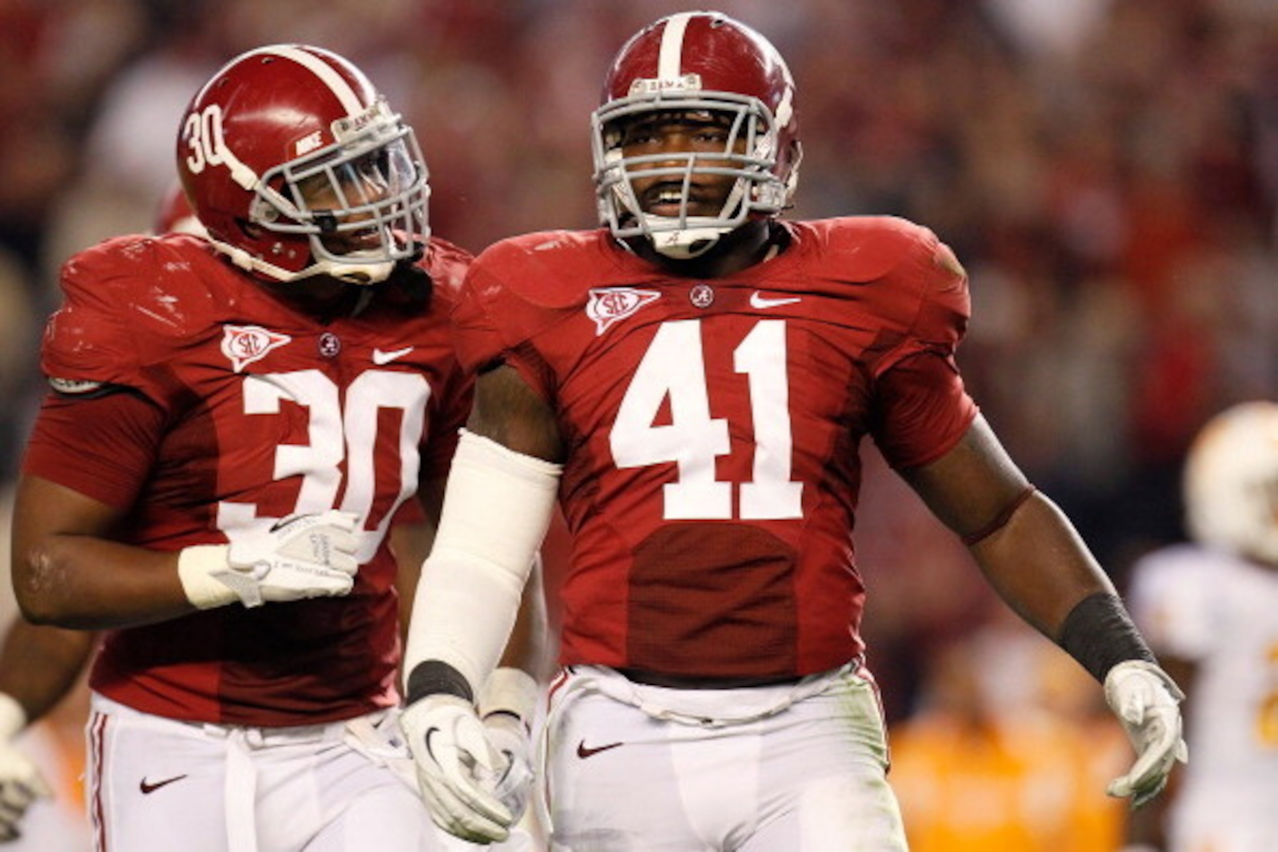 TUSCALOOSA, AL - OCTOBER 22:  Dont'a Hightower #30 and Courtney Upshaw #41 of the Alabama Crimson Tide react after a defensive stop against the Tennessee Volunteers at Bryant-Denny Stadium on October 22, 2011 in Tuscaloosa, Alabama.  (Photo by Kevin C. Co
