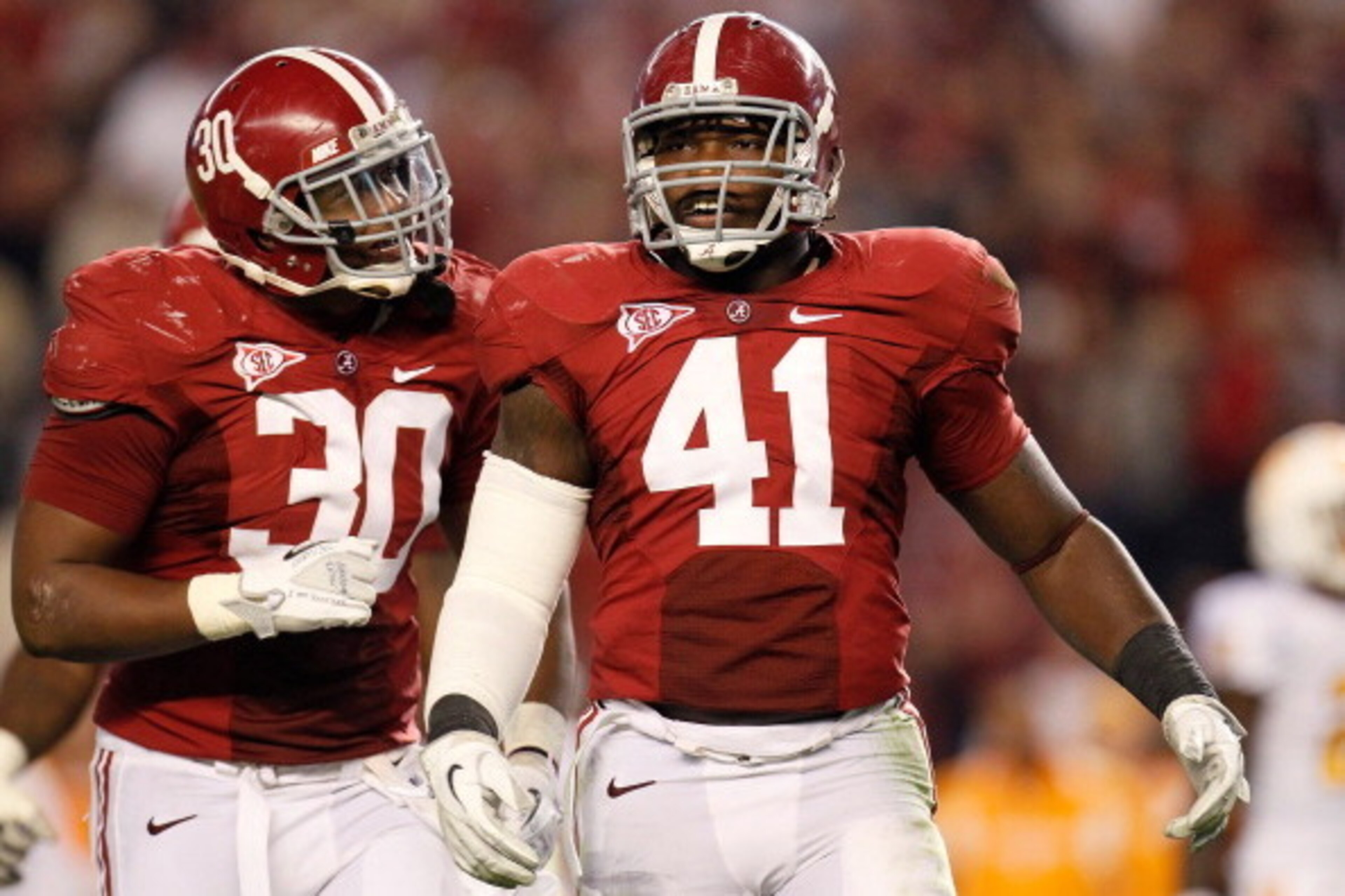 TUSCALOOSA, AL - OCTOBER 22:  Dont'a Hightower #30 and Courtney Upshaw #41 of the Alabama Crimson Tide react after a defensive stop against the Tennessee Volunteers at Bryant-Denny Stadium on October 22, 2011 in Tuscaloosa, Alabama.  (Photo by Kevin C. Co