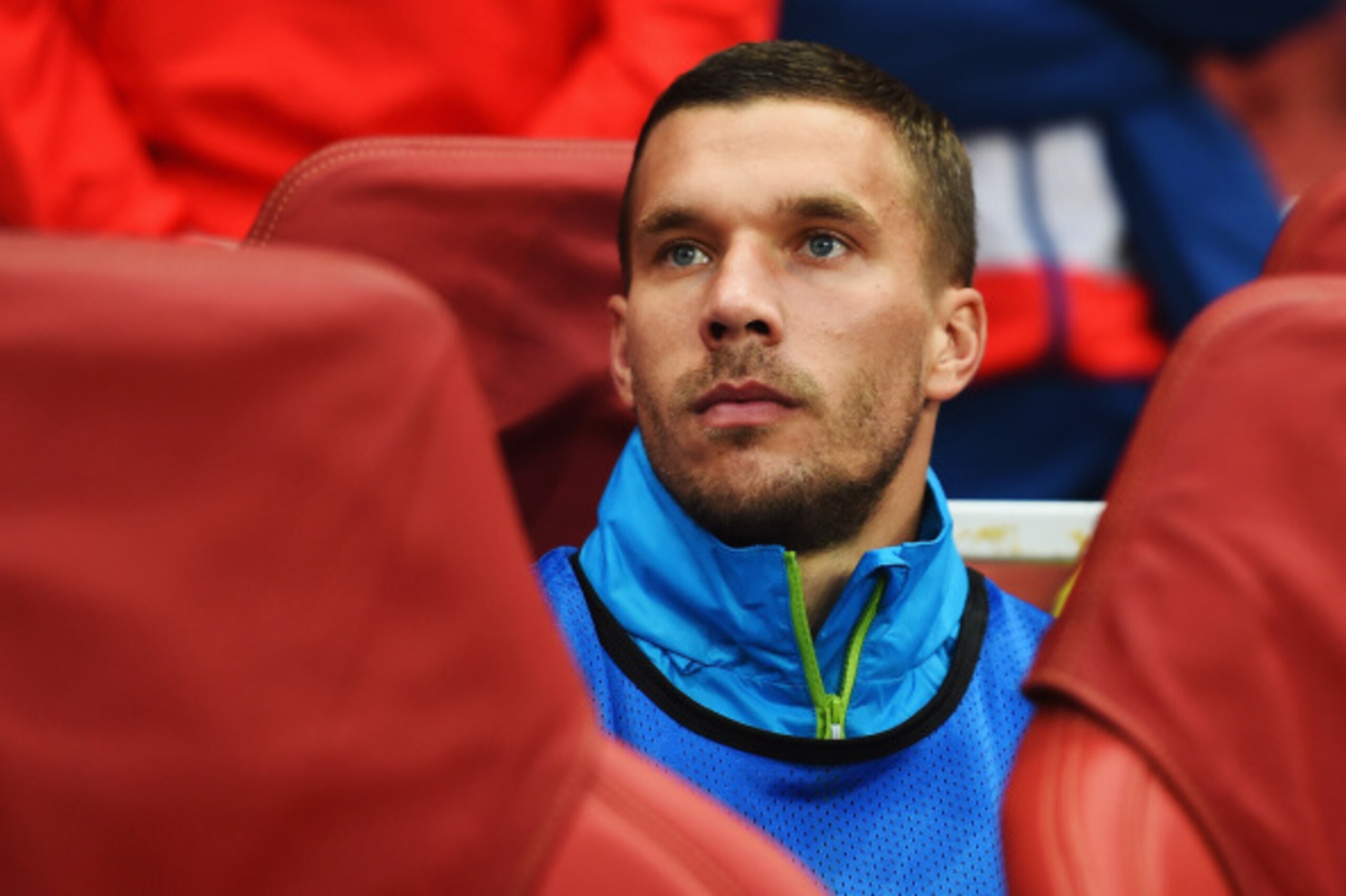 LONDON, ENGLAND - AUGUST 27: Lukas Podolski of Arsenal looks on from the substitutes bench before the UEFA Champions League Qualifier 2nd leg match between Arsenal and Besiktas at the Emirates Stadium on August 27, 2014 in London, United Kingdom.  (Photo 