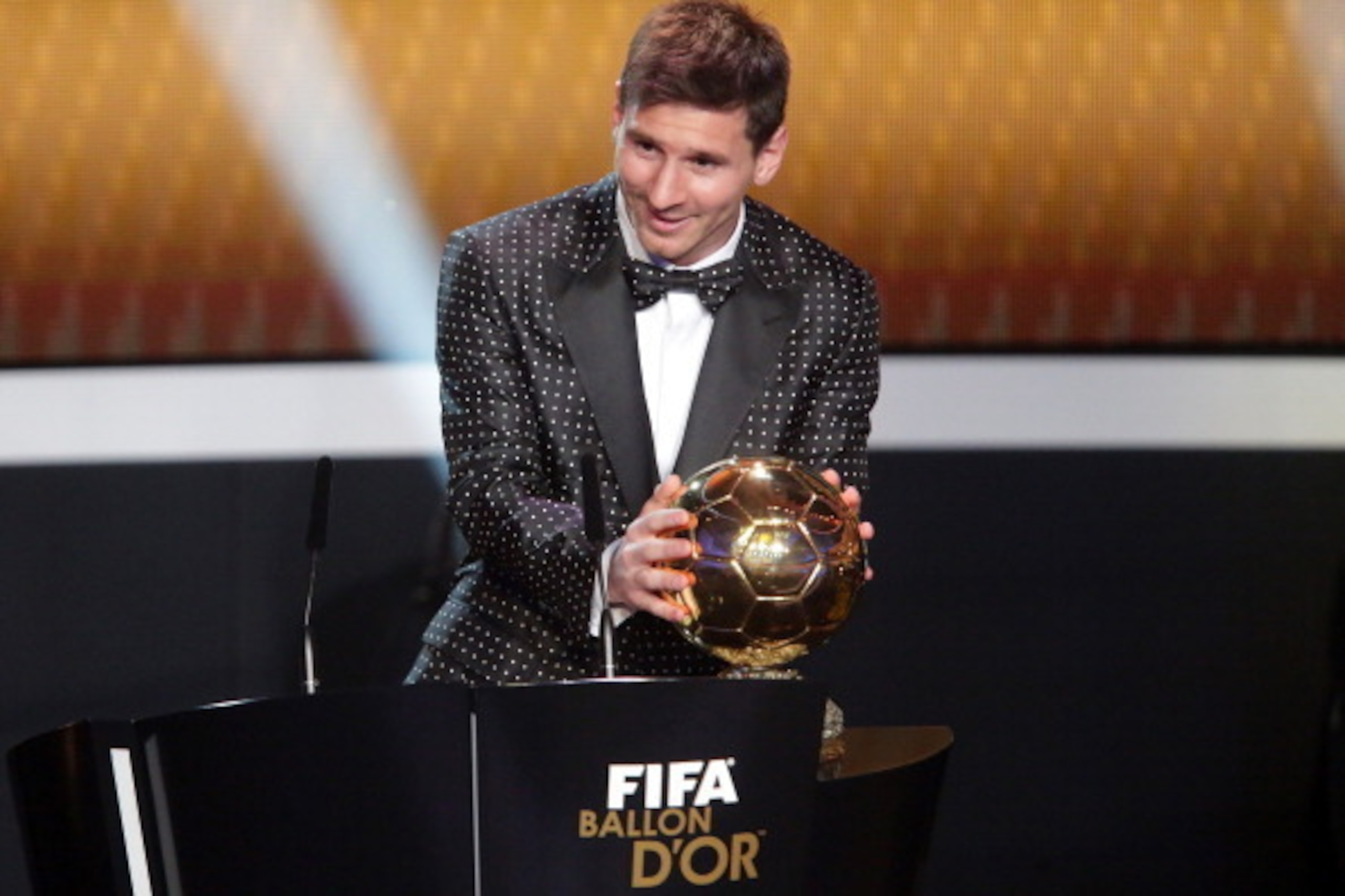 ZURICH, SWITZERLAND - JANUARY 07:  Lionel Messi of Argentina receives the FIFA Ballon d'Or 2012 trophy on January 7, 2013 in Zurich, Switzerland.  (Photo by Christof Koepsel/Getty Images)