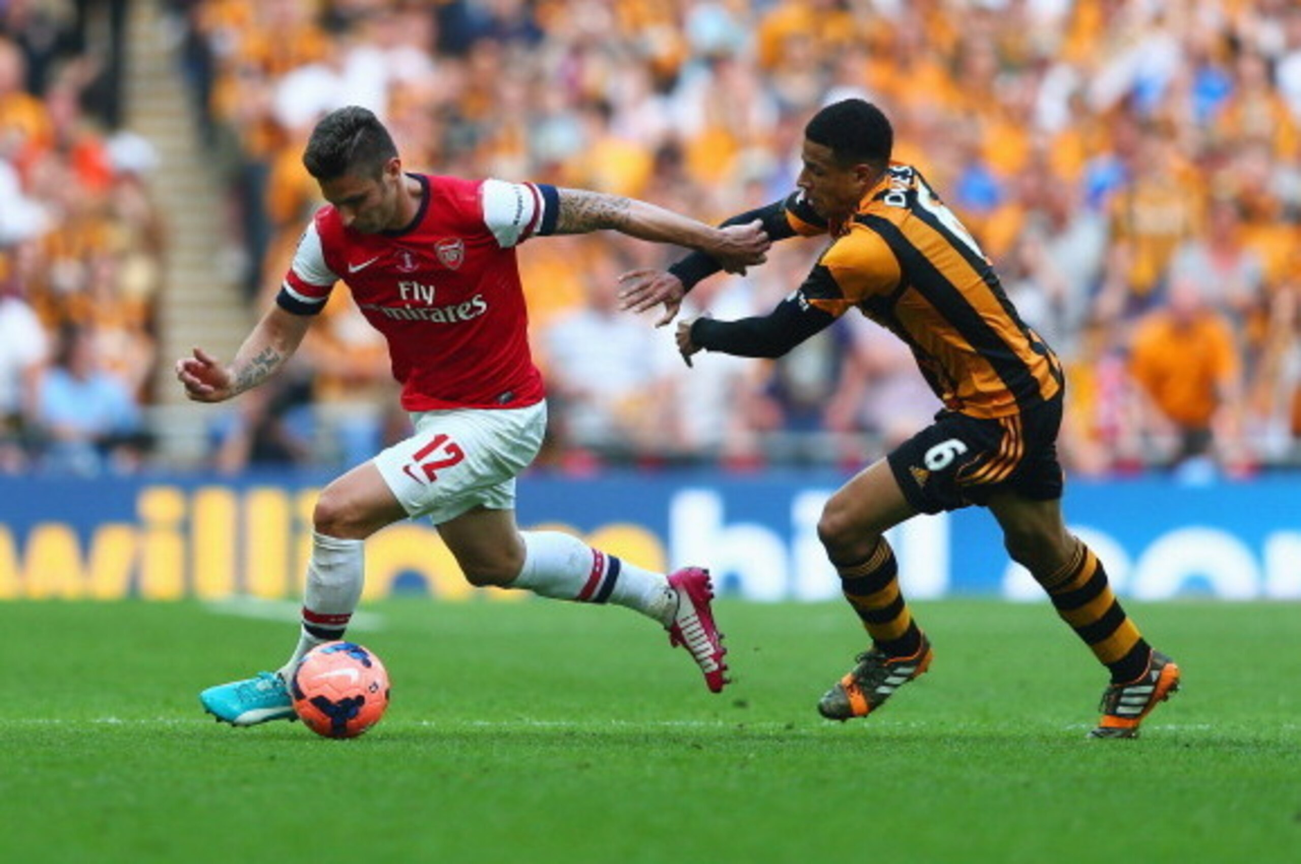 LONDON, ENGLAND - MAY 17:  Olivier Giroud of Arsenal takes on Curtis Davies of Hull City  during the FA Cup with Budweiser Final match between Arsenal and Hull City at Wembley Stadium on May 17, 2014 in London, England.  (Photo by Clive Mason/Getty Images
