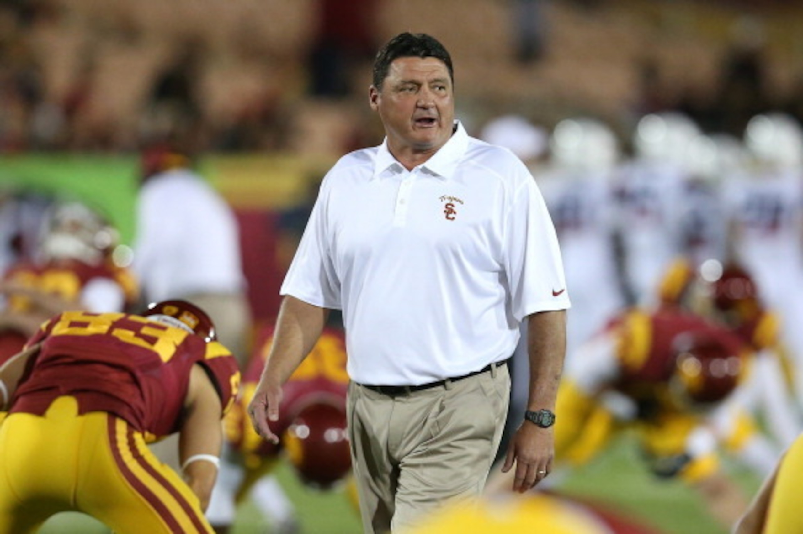 LOS ANGELES, CA - OCTOBER 10: Interim head coach Ed Orgeron of the USC Trojans leads his team as they warm up for the game against the Arizona Wildcats at Los Angeles Coliseum on October 10, 2013 in Los Angeles, California. (Photo by Stephen Dunn/Getty LOS ANGELES, CA - OCTOBER 10: Interim head coach Ed Orgeron of the USC Trojans leads his team as they warm up for the game against the Arizona Wildcats at Los Angeles Coliseum on October 10, 2013 in Los Angeles, California. (Photo by Stephen Dunn/Getty