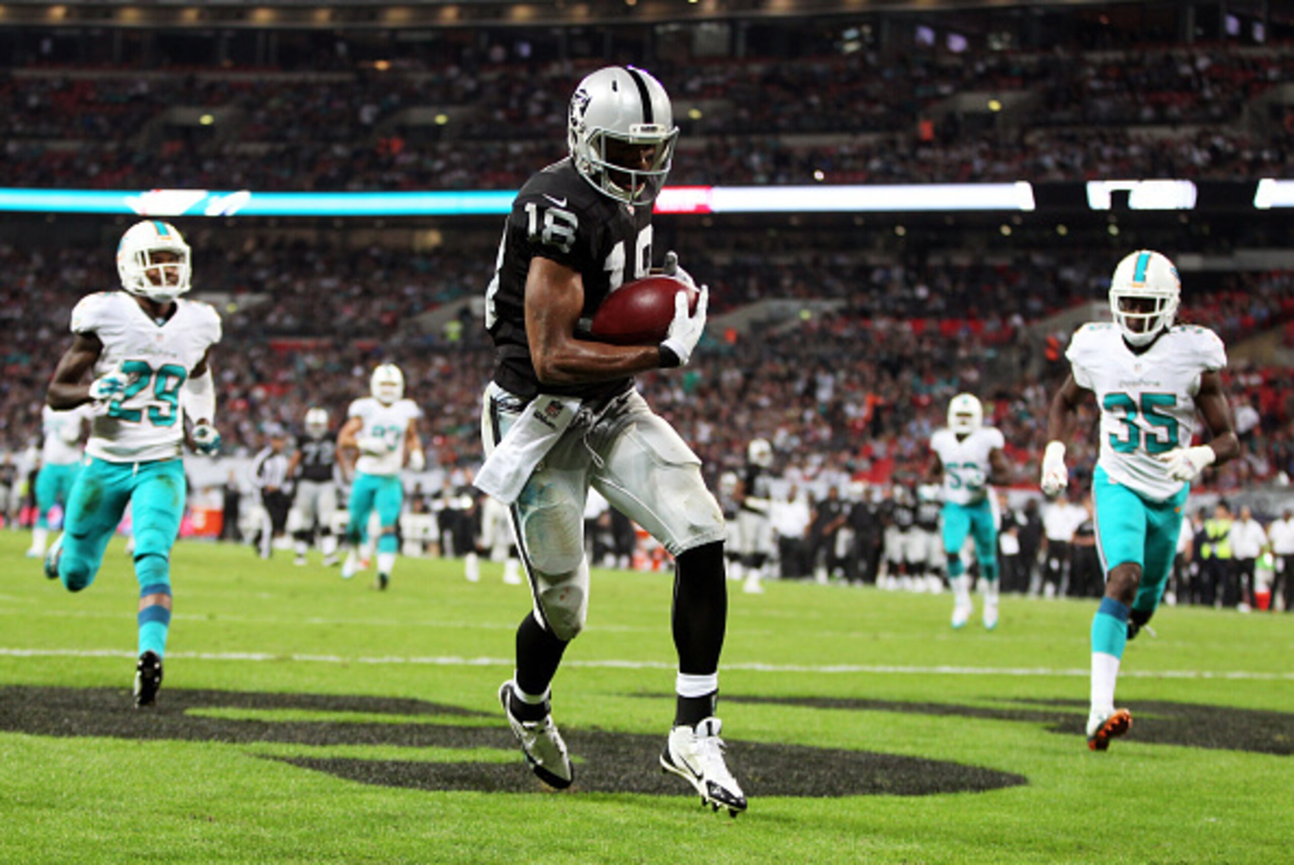 LONDON, ENGLAND - SEPTEMBER 28:  Andre Holmes #18 of the Oakland Raiders makes a 22 yard reception to score his team's second touchdown during the NFL match between the Oakland Raiders and the Miami Dolphins at Wembley Stadium on September 28, 2014 in Lon