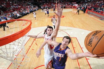HOUSTON, TX - OCTOBER 13:  Goran Dragic #1 of the Phoenix Suns goes up for a shot against the Houston Rockets on October 13, 2014 at the Toyota Center in Houston, Texas. NOTE TO USER: User expressly acknowledges and agrees that, by downloading and or usin