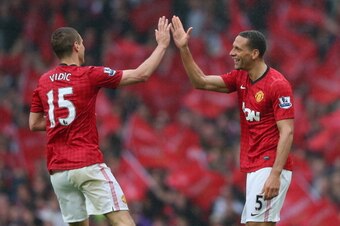MANCHESTER, ENGLAND - MAY 12:  Rio Ferdinand of Manchester United celebrates scoring the winning goal with team-mate Nemanja Vidic during the Barclays Premier League match between Manchester United and Swansea City at Old Trafford on May 12, 2013 in Manch