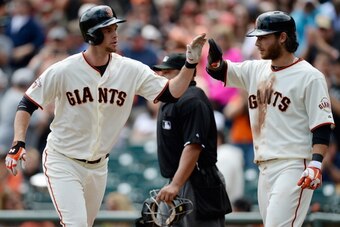 SAN FRANCISCO, CA - AUGUST 08:  Brandon Belt #9 (L) of the San Francisco Giants is congratulated by Brandon Crawford #35 (R) after Belt hit a three-run homer in the first inning against the Milwaukee Brewers at AT&T Park on August 8, 2013 in San Francisco