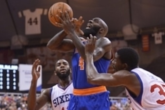 Oct 14, 2014; Syracuse, NY, USA; New York Knicks forward Quincy Acy (4) is fouled going to the basket during the second quarter of a pre-season against the Philadelphia 76ers game at the Carrier Dome. Mandatory Credit: Mark Konezny-USA TODAY Sports
