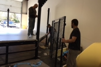 The Millers constructing the cage at their new gym