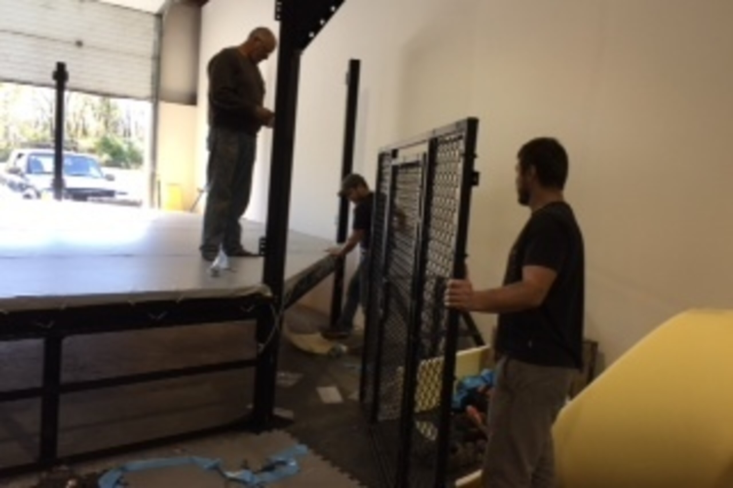 The Millers constructing the cage at their new gym