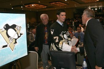 OTTAWA - JULY 30:  First overall draft pick Sidney Crosby of the Pittsburgh Penguins meets with team personnel on the draft floor during the 2005 National Hockey League Draft on July 30, 2005 at the Westin Hotel in Ottawa, Canada.  (Photo by Bruce Bennett
