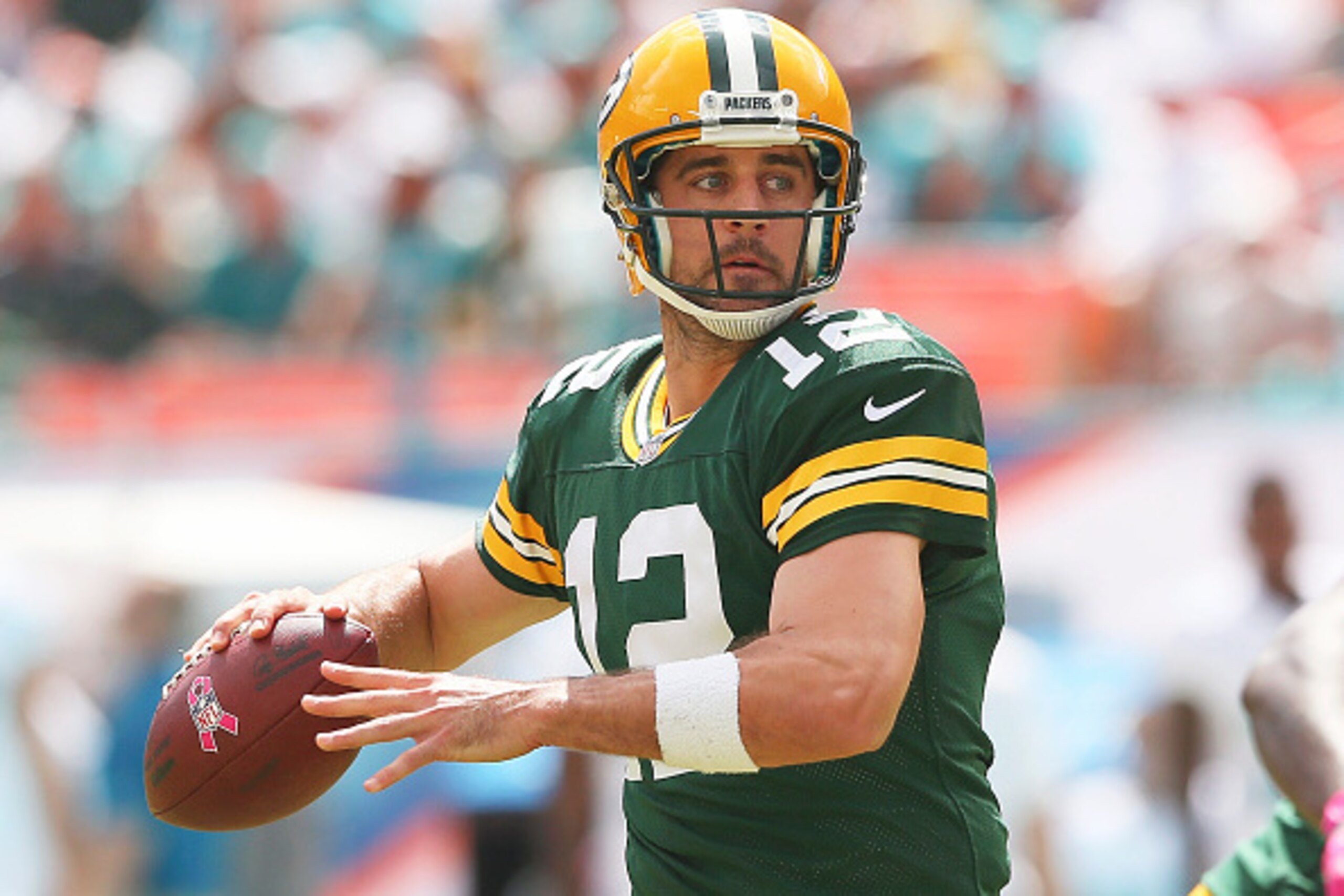 MIAMI GARDENS, FL - OCTOBER 12:  Quarterback Aaron Rodgers #12 of the Green Bay Packers throws in the first quarter during a game against the Miami Dolphins at Sun Life Stadium on October 12, 2014 in Miami Gardens, Florida.  (Photo by Mike Ehrmann/Getty I