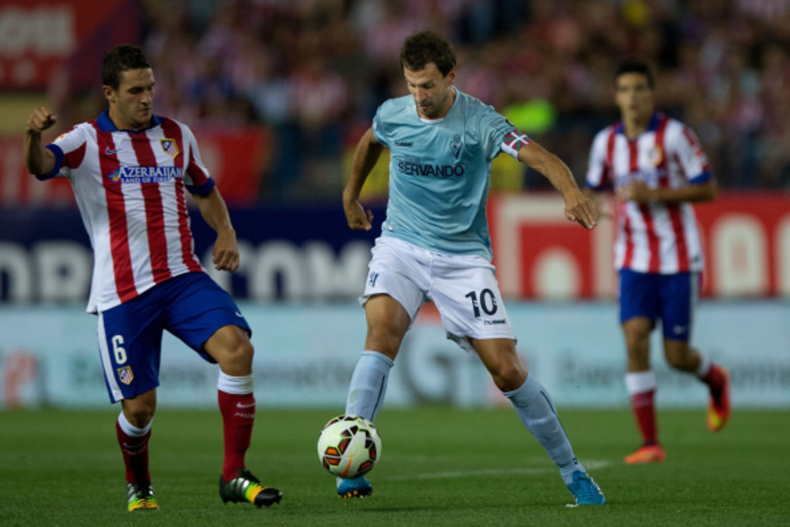 MADRID, SPAIN - AUGUST 30: Captain Mikel Arruabarrena (R) Arambide of SD Eibar competes for the ball with Koke L) of Atletico de Madrid during the La Liga match between Club Atletico de Madrid and SD Eibar at Vicente Calderon Stadium on August 30, 2014 in
