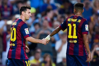 BARCELONA, SPAIN - SEPTEMBER 27:  Lionel Messi of FC Barcelona shakes hands with Neymar of FC Barcelona after scoring his team's sixth goal during the La Liga match between FC Barcelona and Granada CF at Camp Nou on September 27, 2014 in Barcelona, Spain.