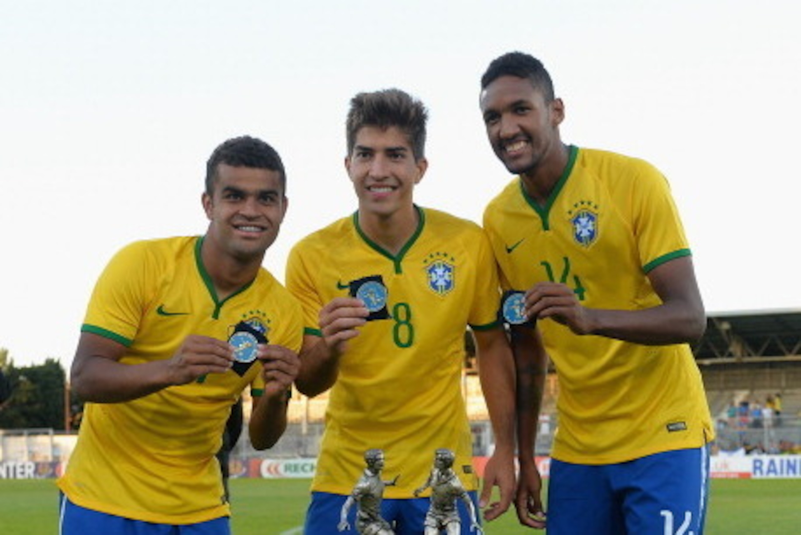 AVIGNON, FRANCE - JUNE 01:  Alisson, Lucas Silva and Wallace of Brazil celebrate their victory with the trophy during the Final of the Toulon Tournament between France and Brazil at the Parc des Sports Avignon on June 1, 2014 in Avignon, France.  (Photo b