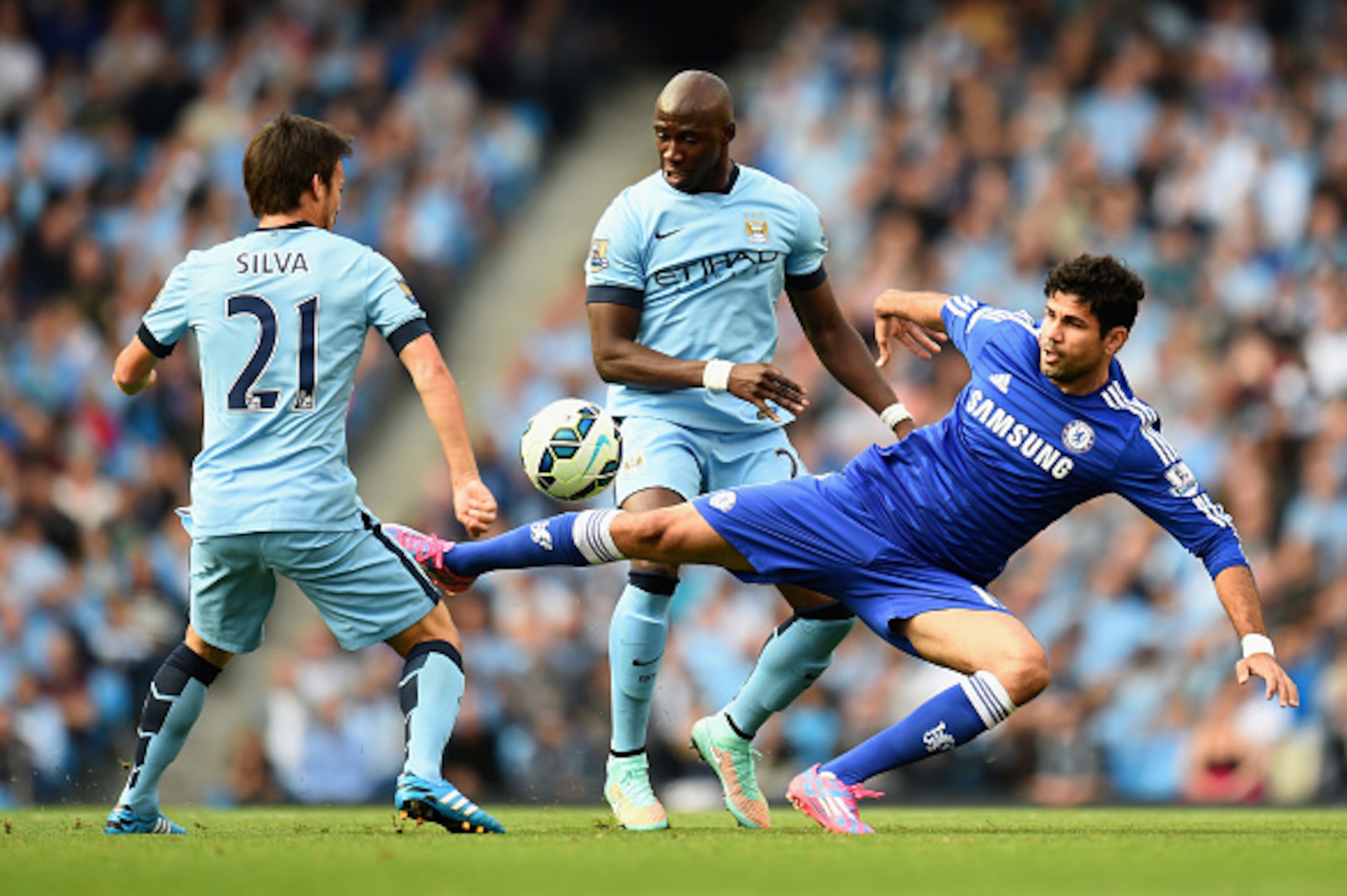 MANCHESTER, ENGLAND - SEPTEMBER 21:  David Silva and Eliaquim Mangala of Manchester City compete with Diego Costa of Chelsea during the Barclays Premier League match between Manchester City and Chelsea at the Etihad Stadium on September 21, 2014 in Manche