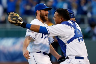 KANSAS CITY, MO - OCTOBER 15:  Greg Holland #56 and Salvador Perez #13 of the Kansas City Royals celebrates their 2 to 1 win over the Baltimore Orioles to sweep the series in Game Four of the American League Championship Series at Kauffman Stadium on Octo
