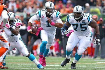 CINCINNATI, OH - OCTOBER 12:  Fernando Velasco #75 of the Carolina Panthers looks to clear a path as Cam Newton #1 of the Carolina Panthers runs towards the end zone during the third quarter against the Cincinnati Bengals  at Paul Brown Stadium on October