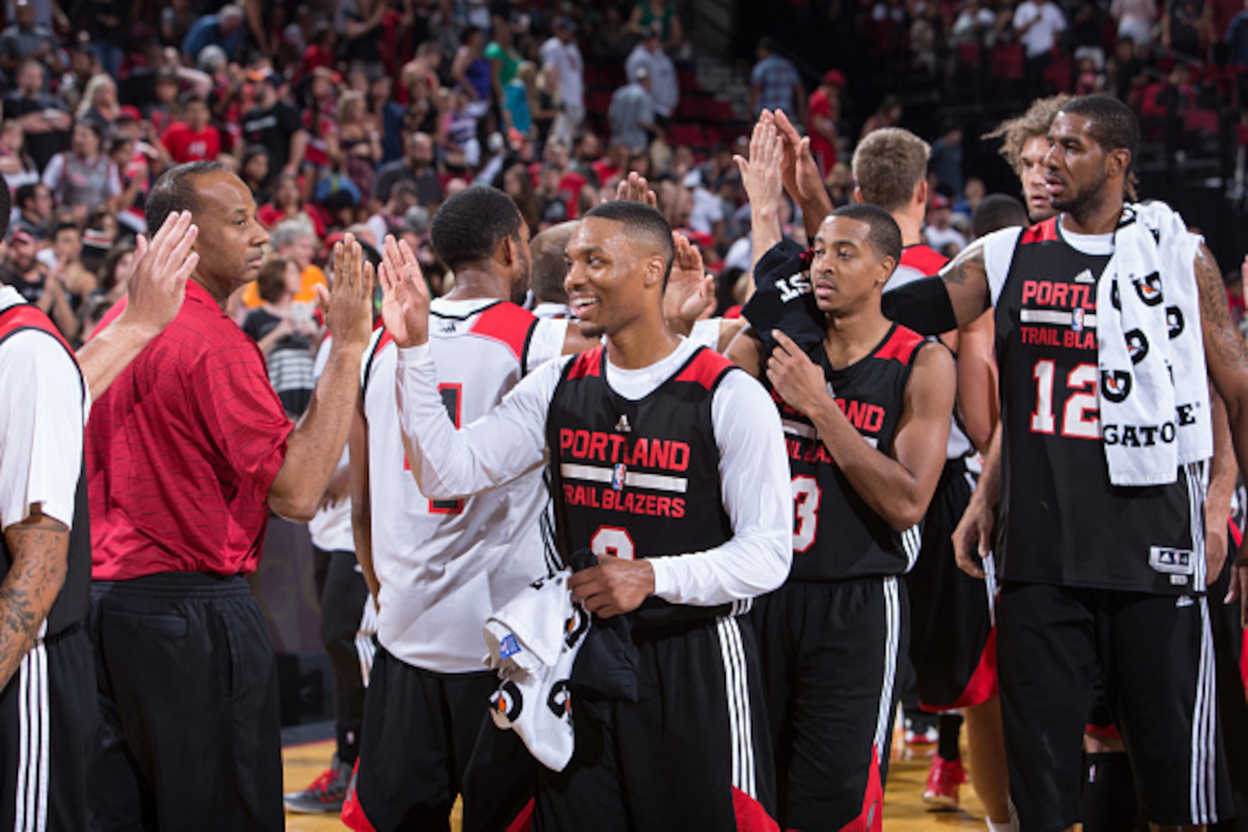 PORTLAND, OR - OCTOBER 5: Damian Lillard #0 , C.J. McCollum #3 and LaMarcus Aldridge #12 of the Portland Trail Blazers share their team spirit while participating in the team's annual 'Fan Fest', a free to the public scrimmage October 5, 2014 at the Moda 