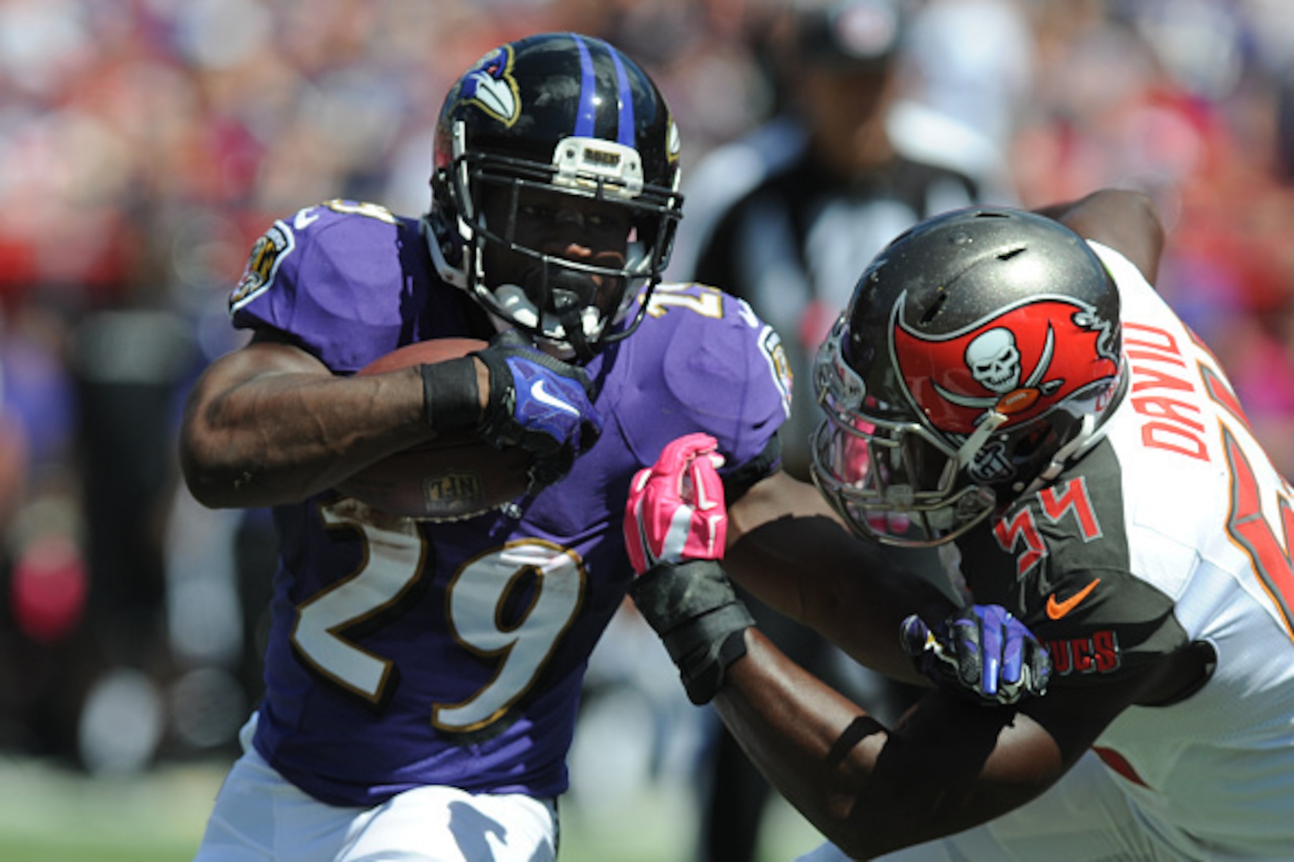 TAMPA, FL - OCTOBER 12: Running back Justin Forsett #29 of the Baltimore Ravens carries the ball as outside linebacker Lavonte David #54 of the Tampa Bay Buccaneers defends at Raymond James Stadium on October 12, 2014 in Tampa, Florida. (Photo by Cliff Mc