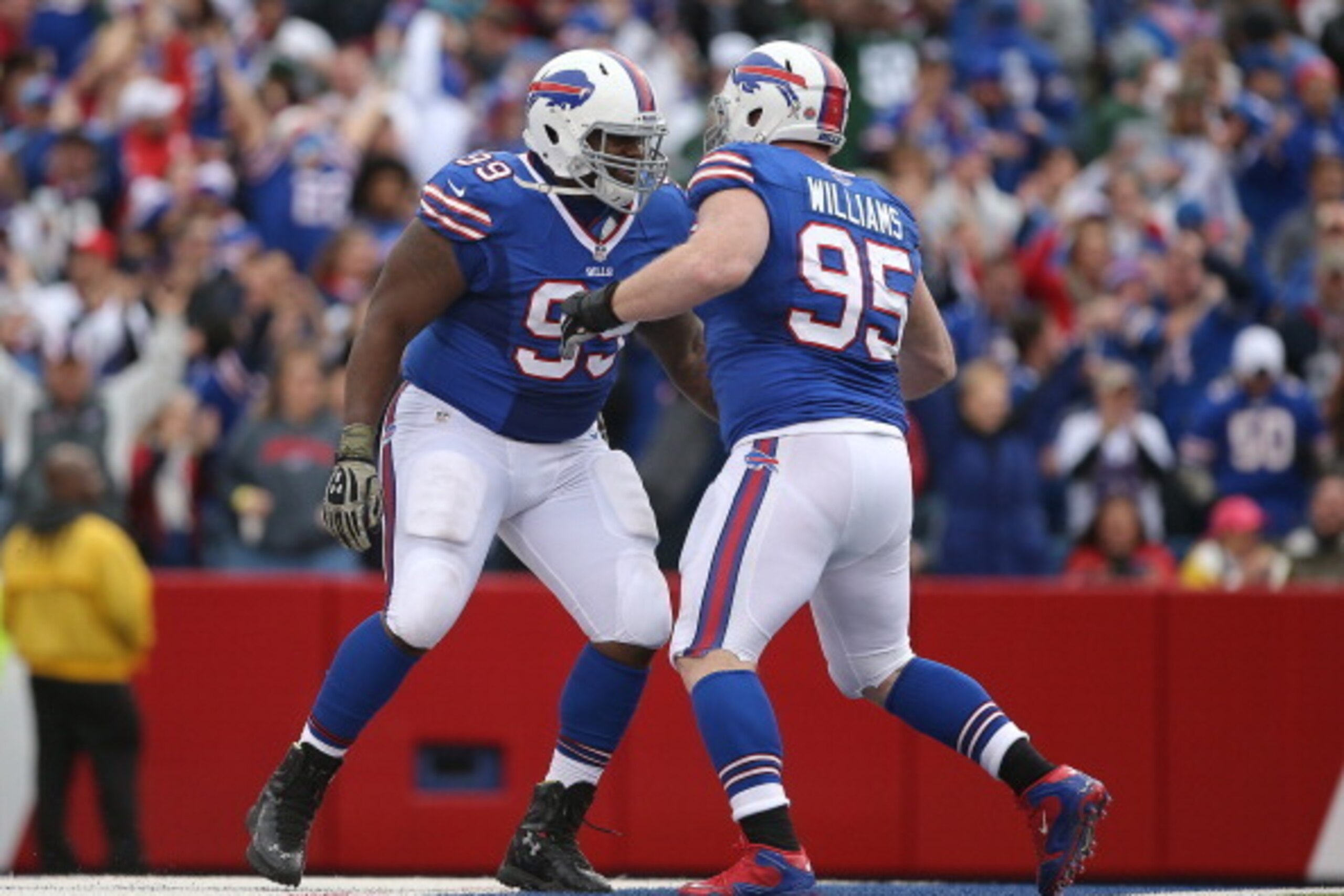 ORCHARD PARK, NY - NOVEMBER 17: Marcell Dareus #99 of the Buffalo Bills celebrates with Kyle Williams #95 after Williams forced a turnover during NFL game action against the New York Jets at Ralph Wilson Stadium on November 17, 2013 in Orchard Park, New Y