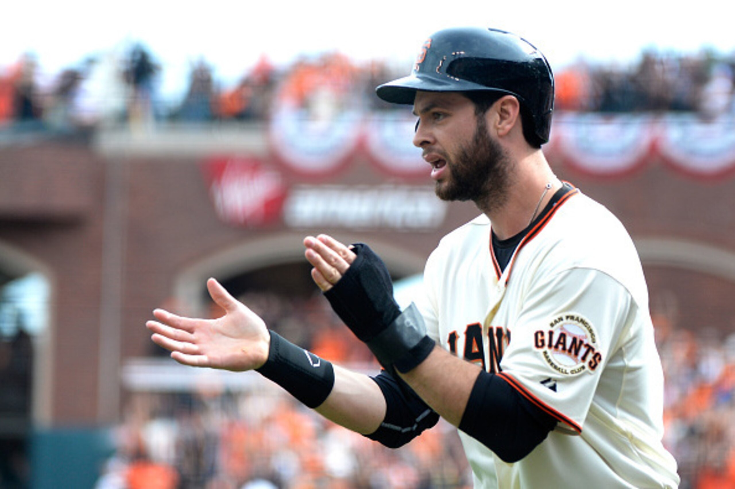 SAN FRANCISCO, CA - OCTOBER 14:  Brandon Belt #9 of the San Francisco Giants celebrates after scoring in the first inning against the St. Louis Cardinals during Game Three of the National League Championship Series at AT&T Park on October 14, 2014 in San 