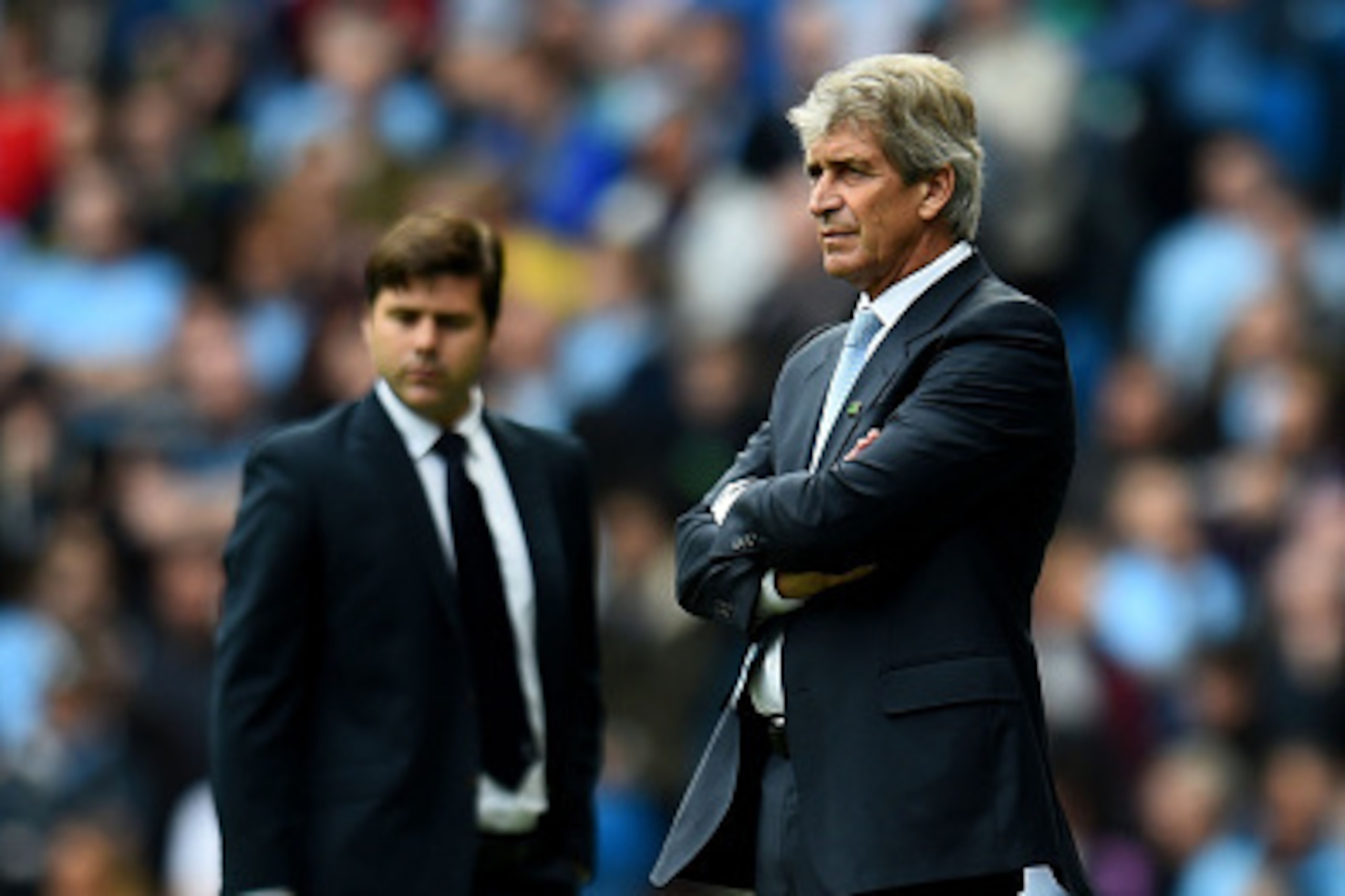 MANCHESTER, ENGLAND - OCTOBER 18:  Manuel Pellegrini the manager of Manchester City and Mauricio Pochettino the manager of Spurs look on during the Barclays Premier League match between Manchester City and Tottenham Hotspur at Etihad Stadium on October 18